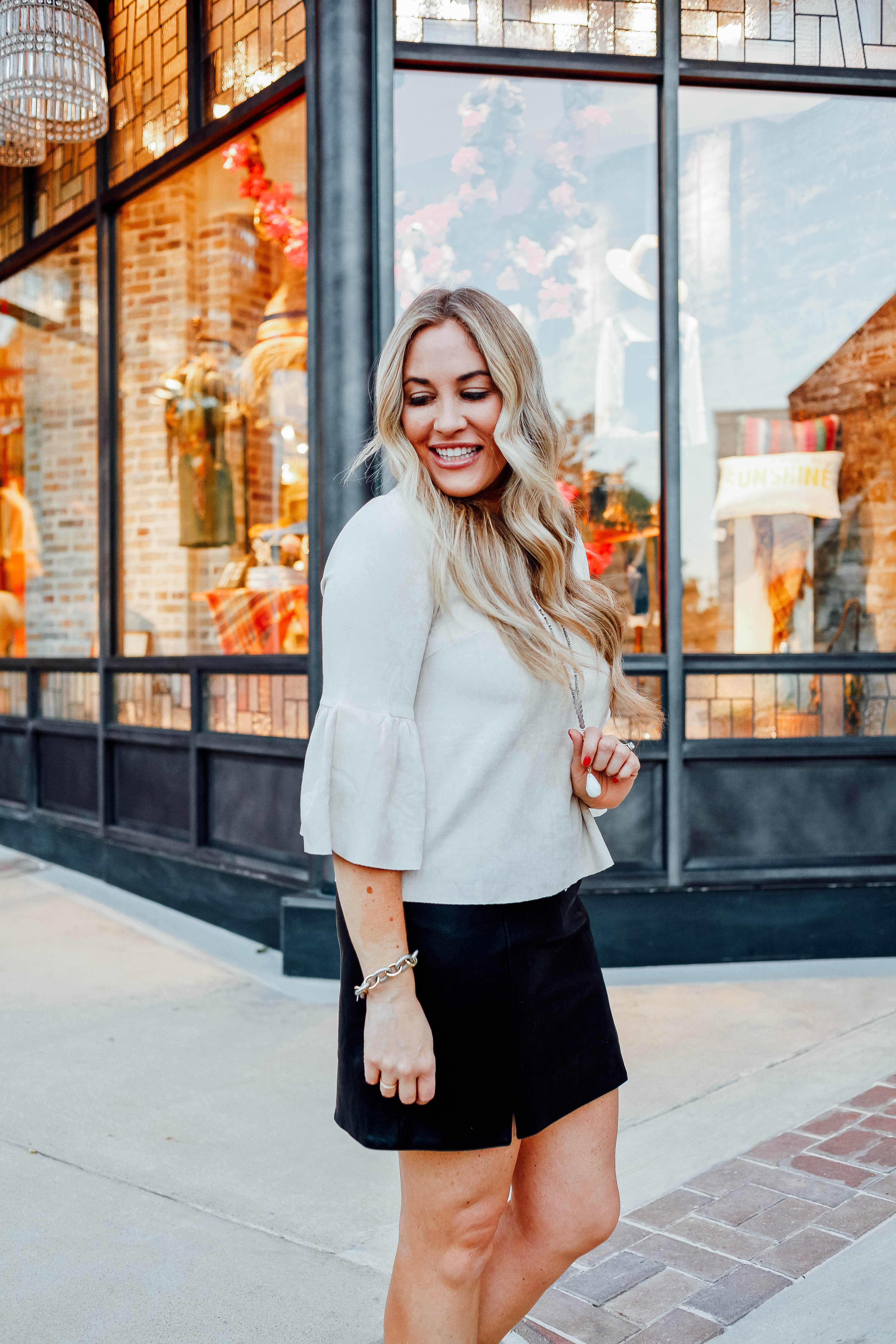 Fall Fashion Essentials featured by top US fashion blog, Walking in Memphis in High Heels: image of a woman wearing snakeskin leather booties, faux leather mini skirt, suede bell sleeve top from Altar'd Sata.