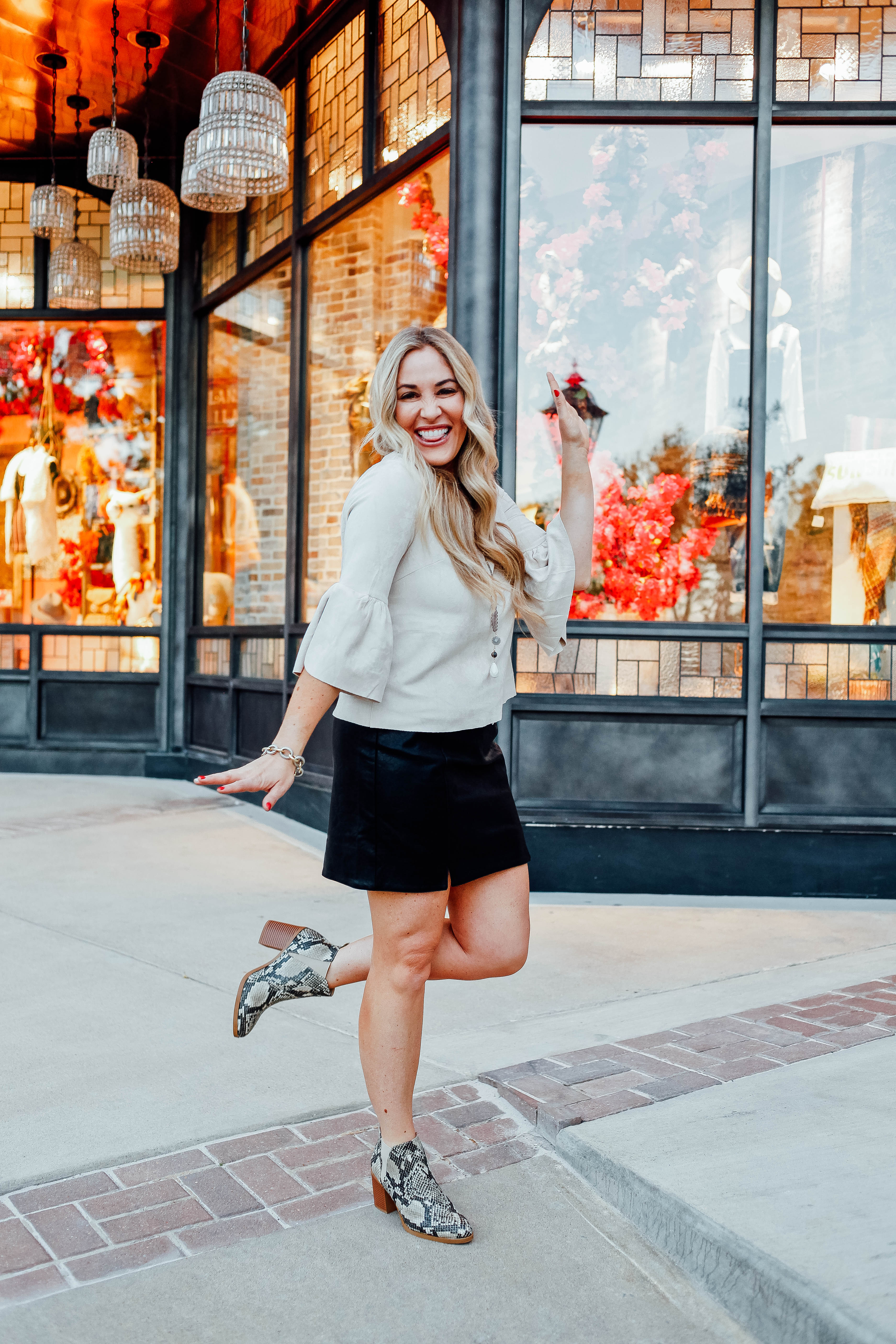 Fall Fashion Essentials featured by top US fashion blog, Walking in Memphis in High Heels: image of a woman wearing snakeskin leather booties, faux leather mini skirt, suede bell sleeve top from Altar'd Sata.