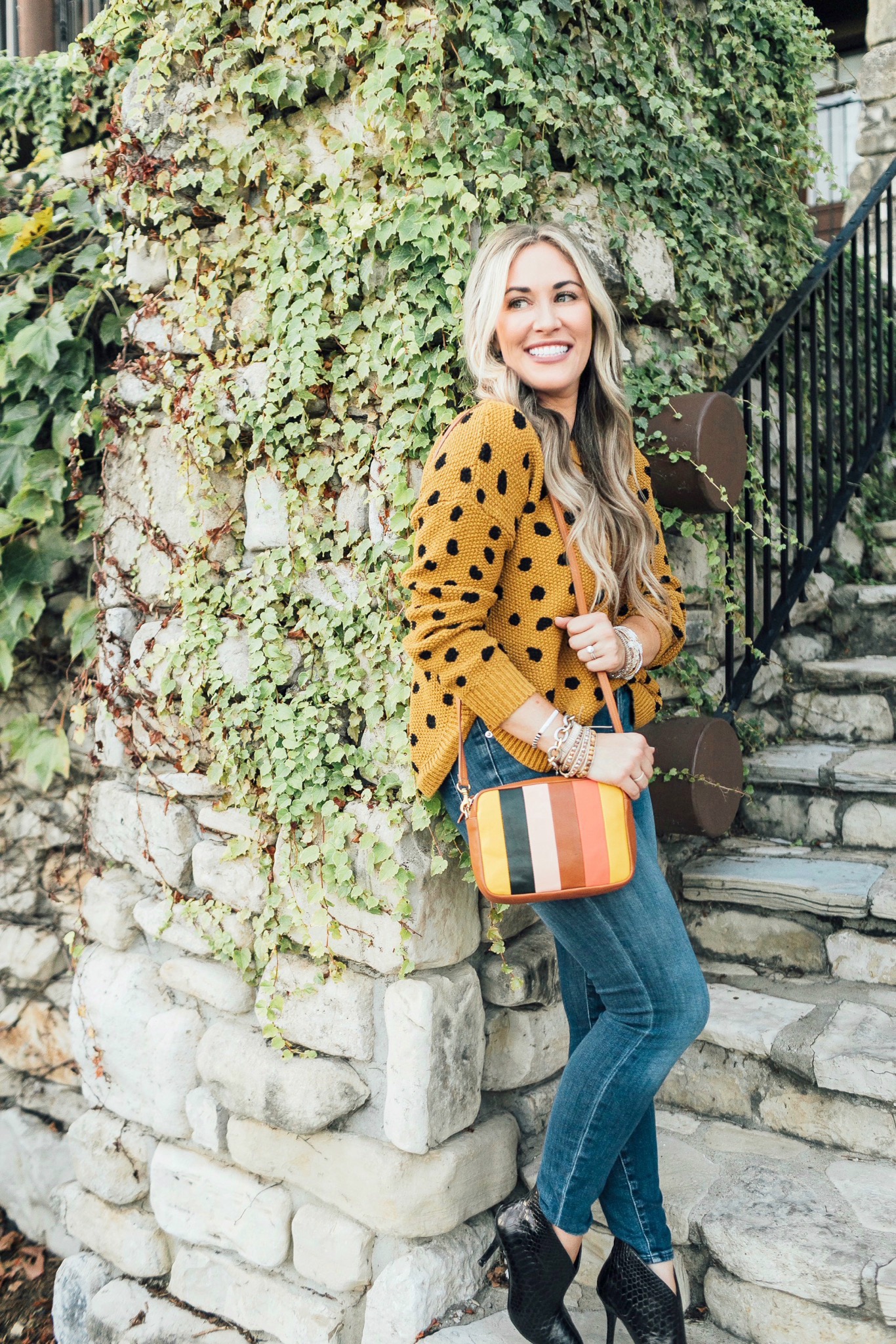 Fall trend colors featured by top US fashion blog, Walking in Memphis in High Heels: image of a woman wearing Good American skinny jeans, Vince Camuto booties, Clare V. Striped crossbody bags, and  Victoria Emerson stackable bracelets.