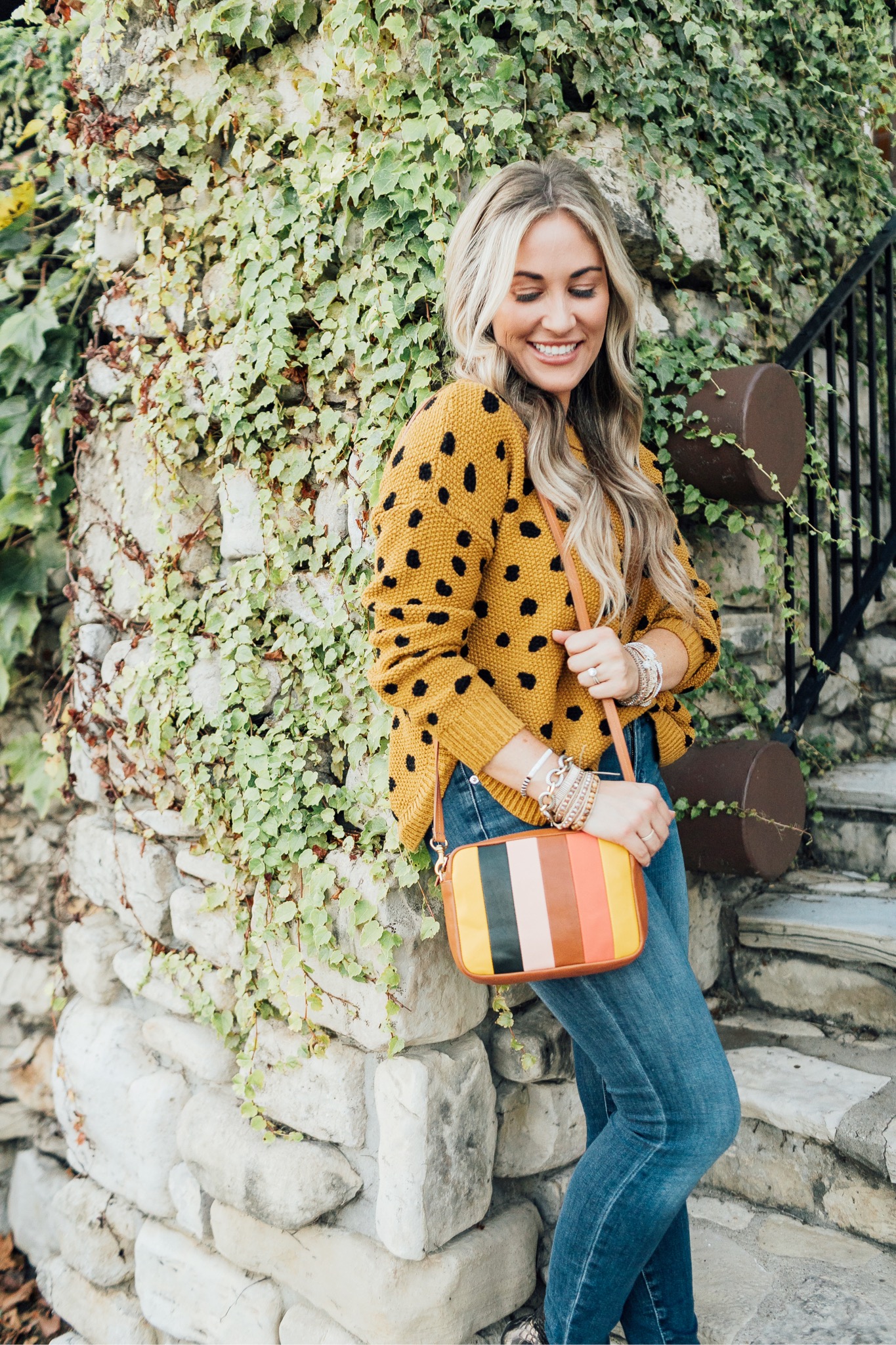 Fall trend colors featured by top US fashion blog, Walking in Memphis in High Heels: image of a woman wearing Good American skinny jeans, Vince Camuto booties, Clare V. Striped crossbody bags, and  Victoria Emerson stackable bracelets.