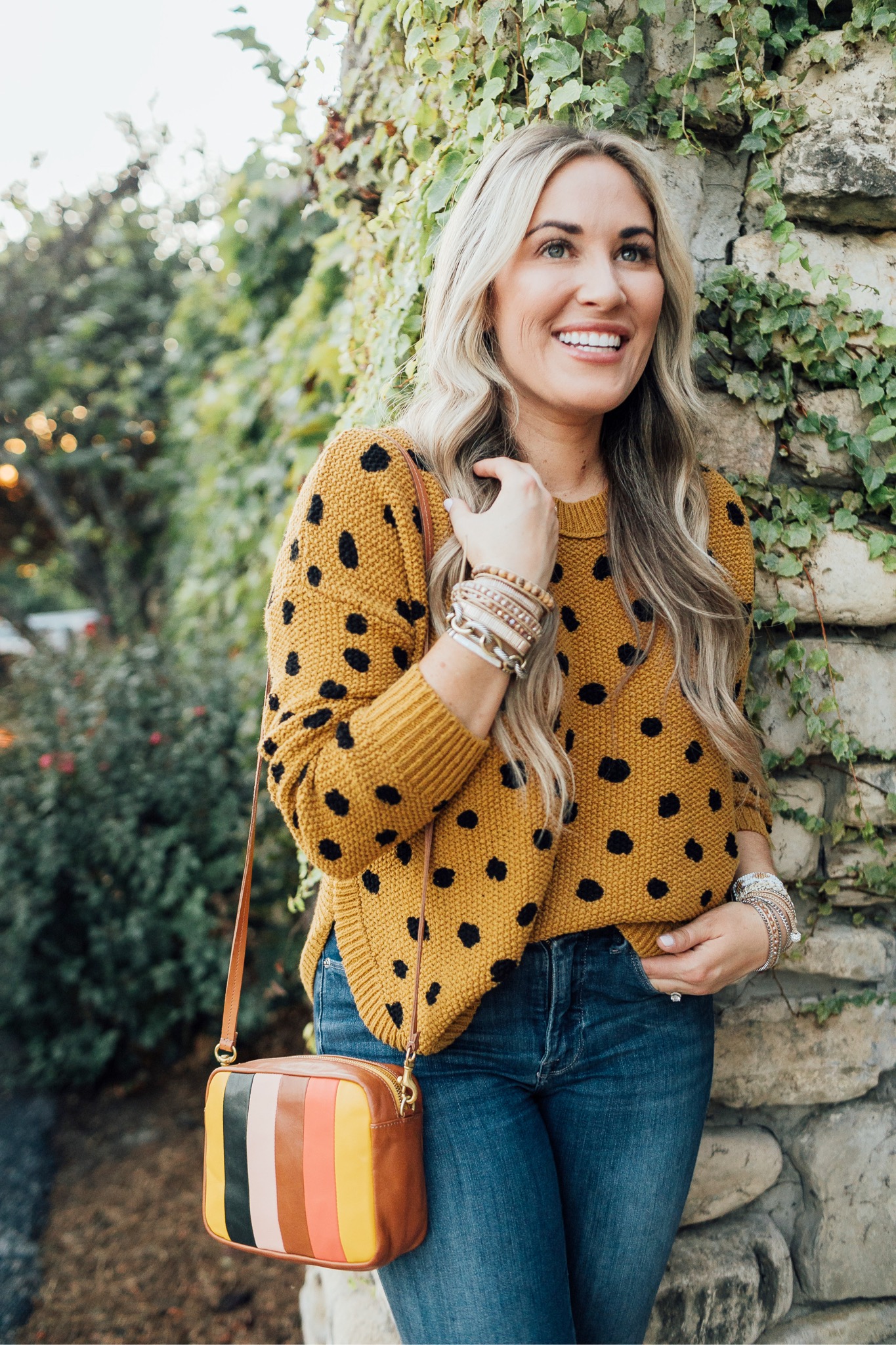 Fall trend colors featured by top US fashion blog, Walking in Memphis in High Heels: image of a woman wearing Good American skinny jeans, Vince Camuto booties, Clare V. Striped crossbody bags, and  Victoria Emerson stackable bracelets.