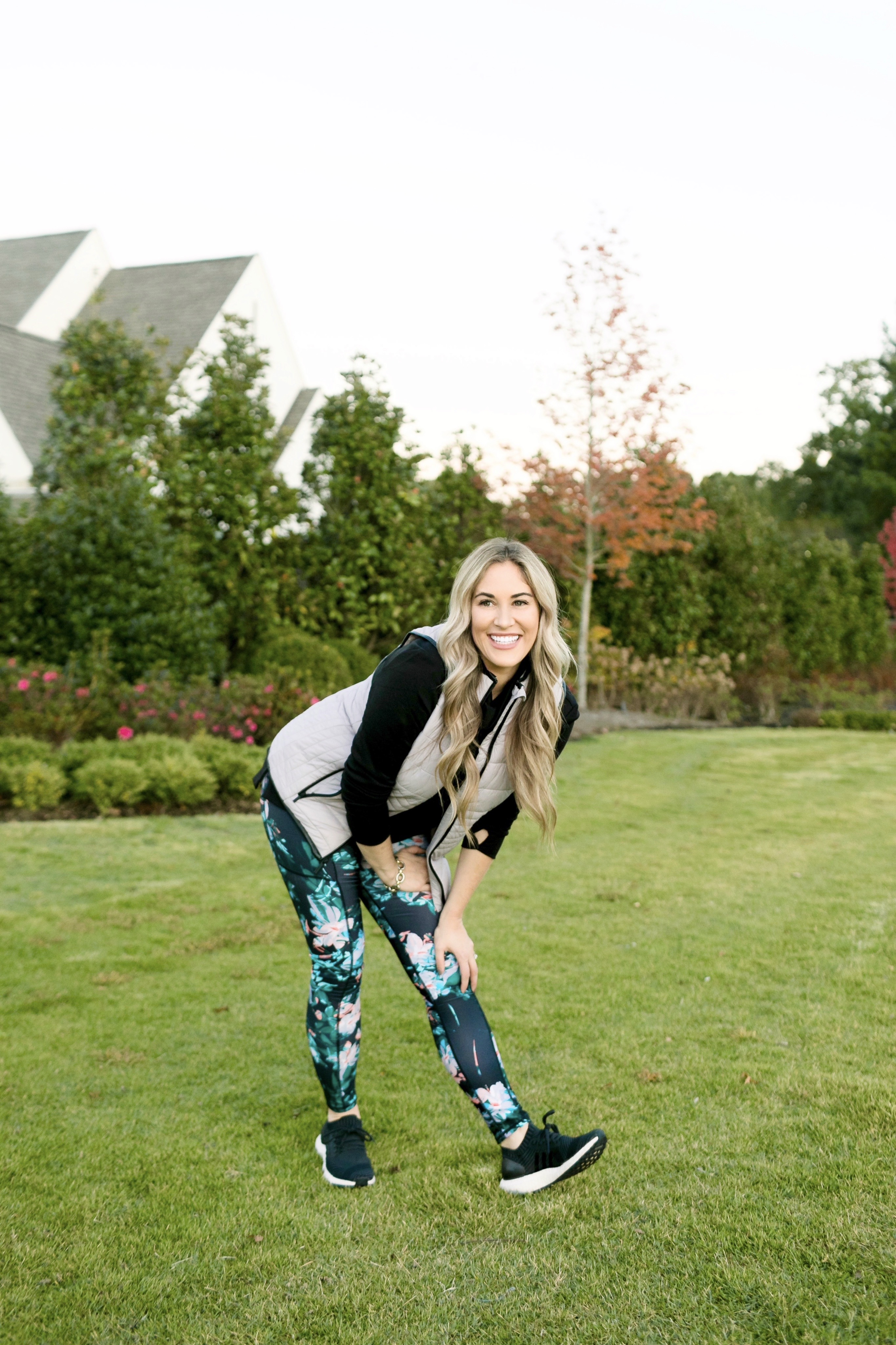 Holiday Honey Hustle fitness Challenge Week 2 featured by top US fitness blog, Walking in Memphis in High Heels: image of a woman wearing a Marc New York Performance black sweatshirt, Marc New York Performance floral leggings, Marc New York Performance puffer vest and Adidas Ultraboost running shoes