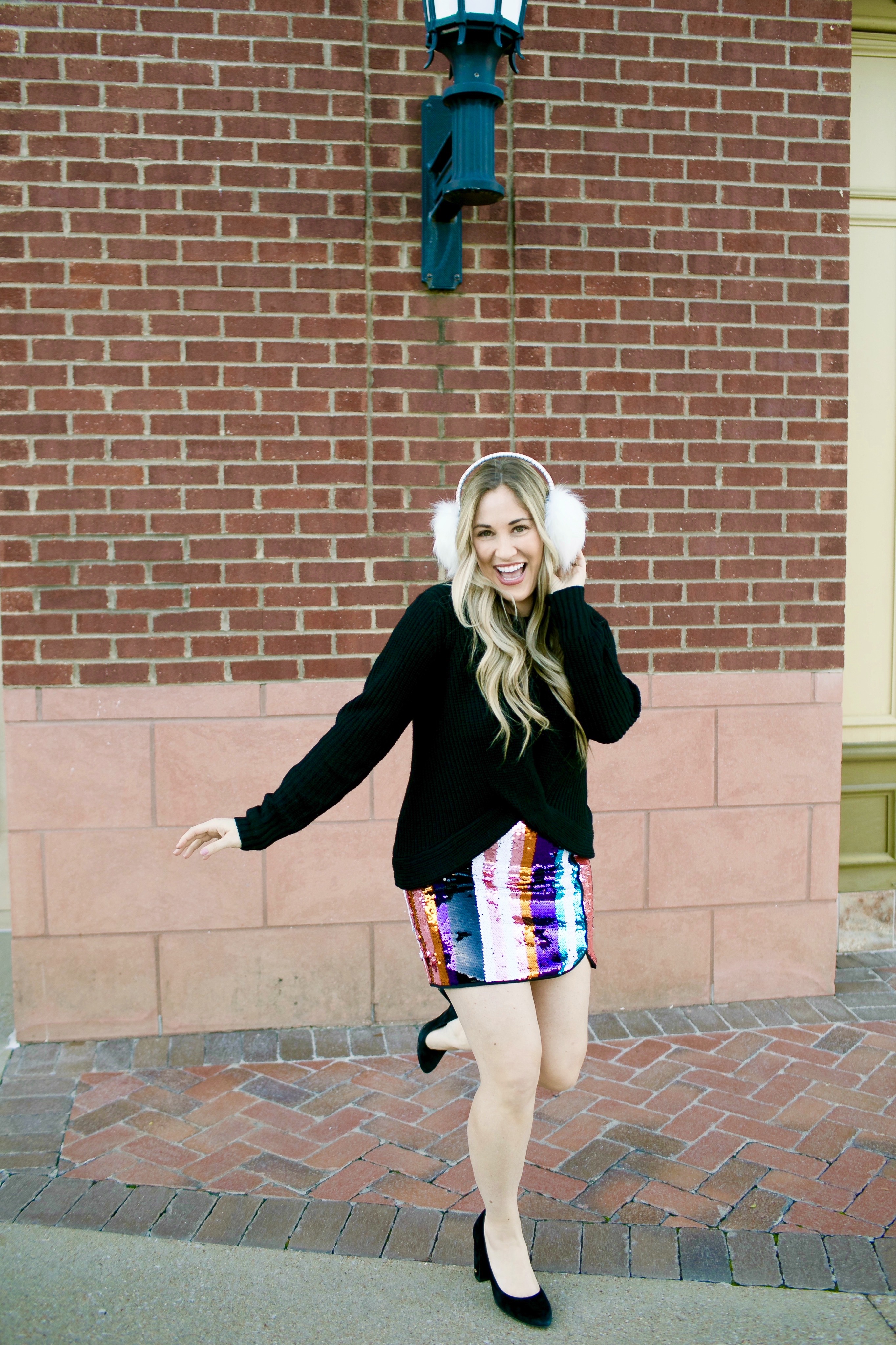 Holiday Style featured by top Memphis fashion blog, Walking in Memphis in High Heels: image of a woman wearing Francesca's sequin mini skirt, Francesc's sweater, Francesca's furry ear muffs, and San Edelman pumps.
