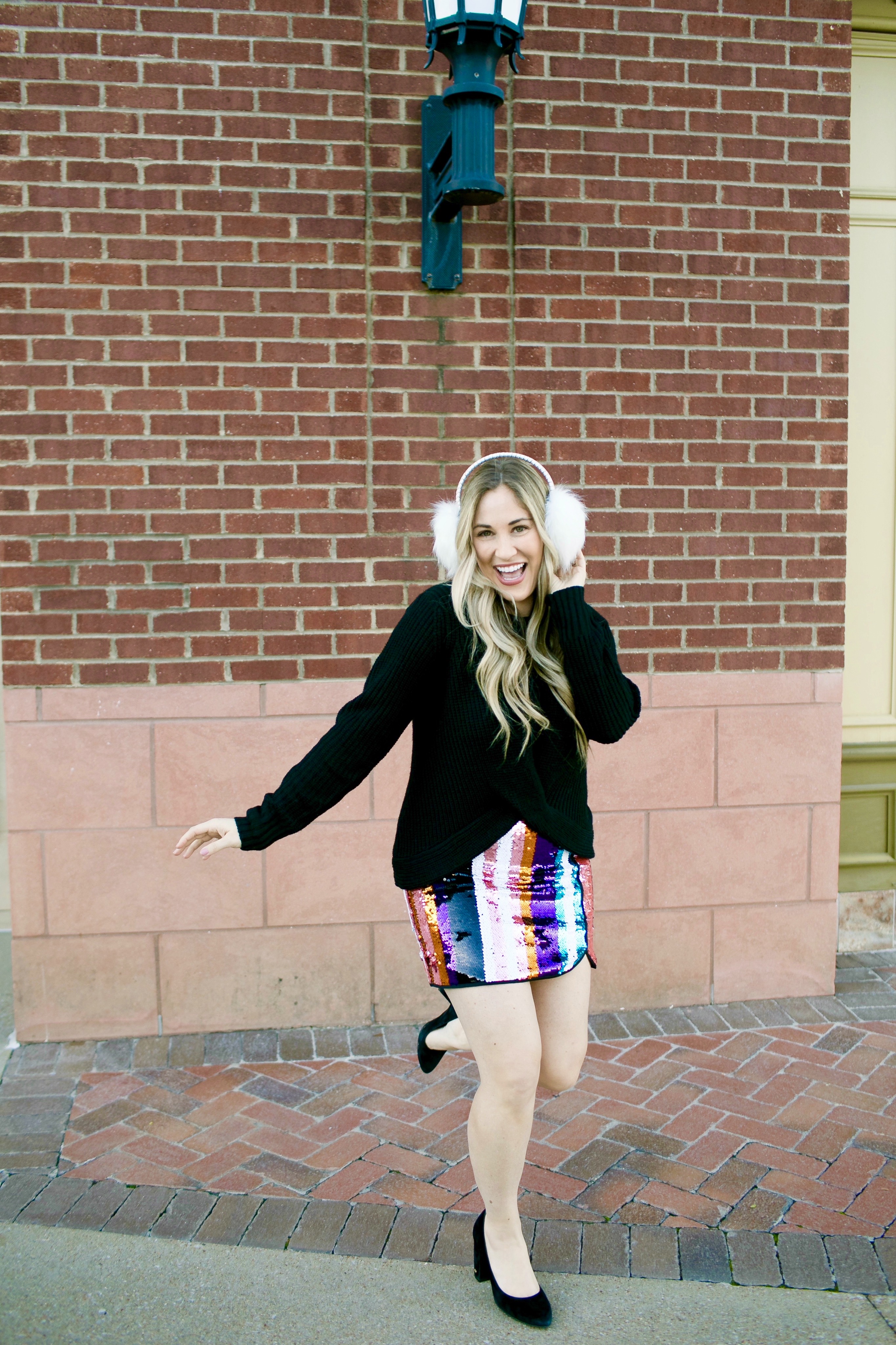 Holiday Style featured by top Memphis fashion blog, Walking in Memphis in High Heels: image of a woman wearing Francesca's sequin mini skirt,  Francesc's sweater, Francesca's furry ear muffs, and San Edelman pumps.