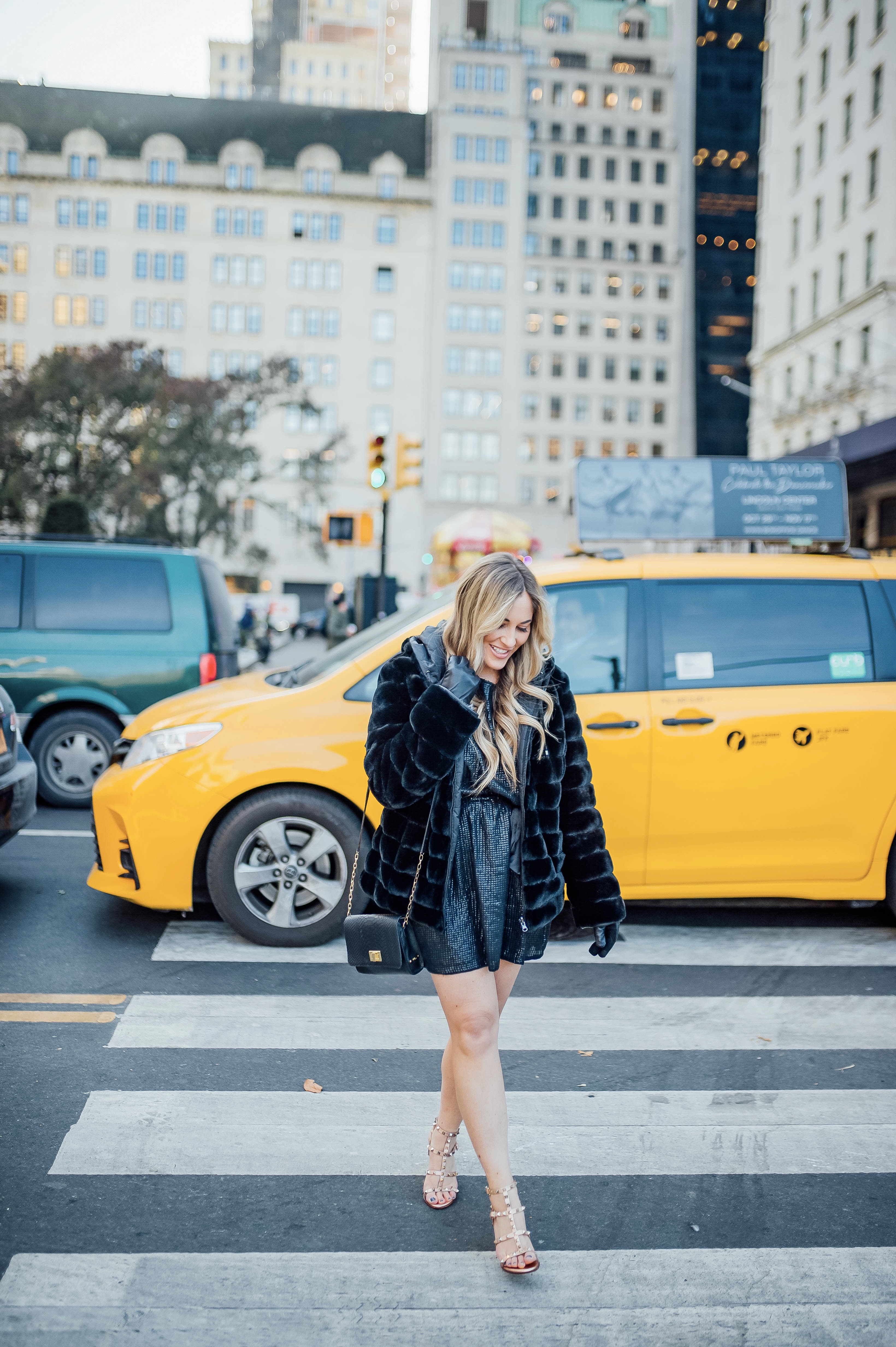 Holiday event style for NYE, Holiday Weddings, Holiday Parties featured by top US fashion blog, Walking in Memphis in High Heels: image of a woman wearing Lana A Boutique puffer jacket, Gigi New York crossbody bag, Valentino Garavani heeled sandals, Kohl’s faux fur leather tech gloves, and a Red Dress Boutique silver dress.