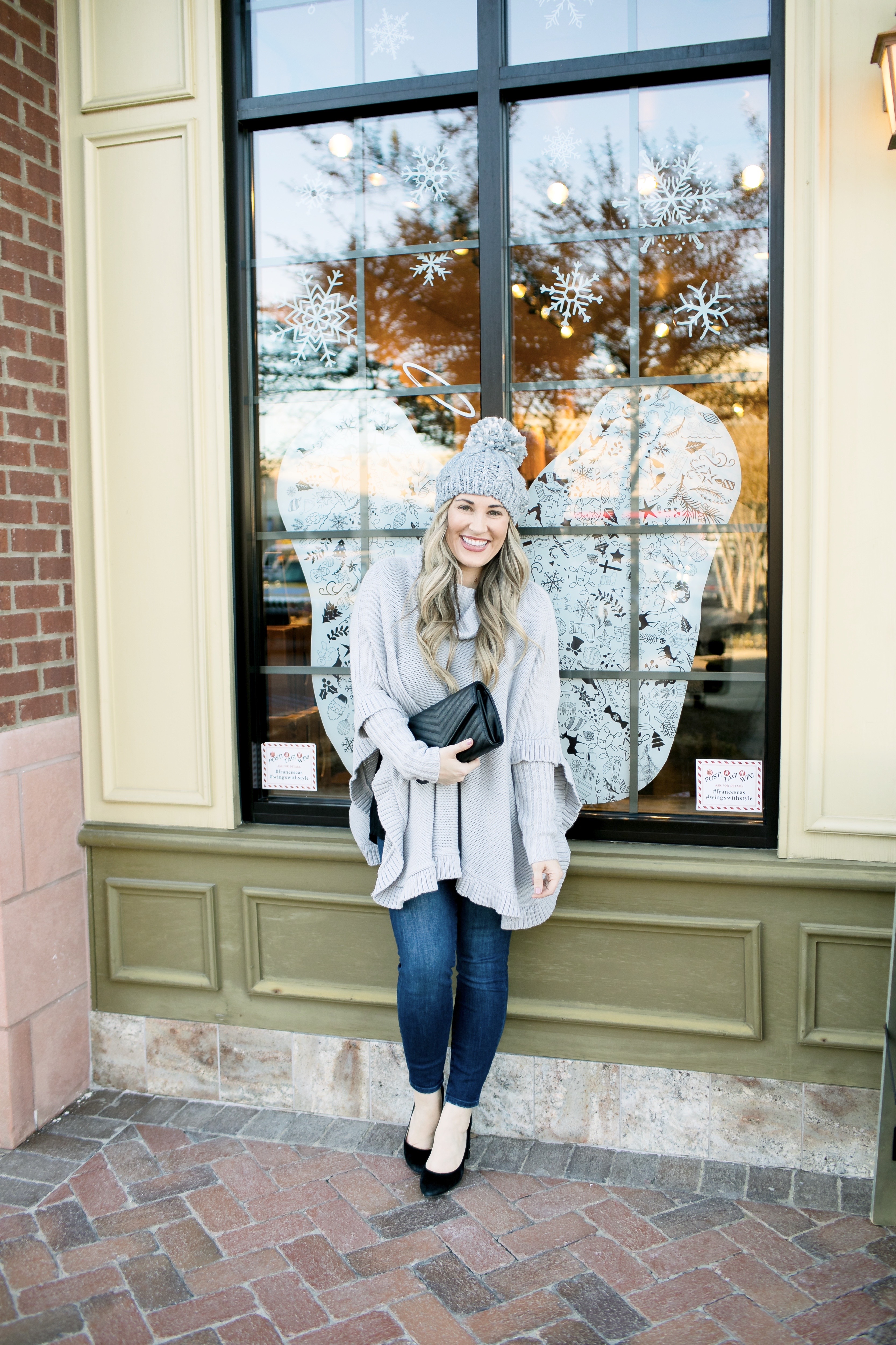 Last Minute Stocking Stuffers from Francesca's at Carriage Crossing featured by top US fashion blog, Walking in Memphis in High Heels: image of a woman wearing Francesca's straight jeans, a quilted clutch, a beanie hat and and a poncho.