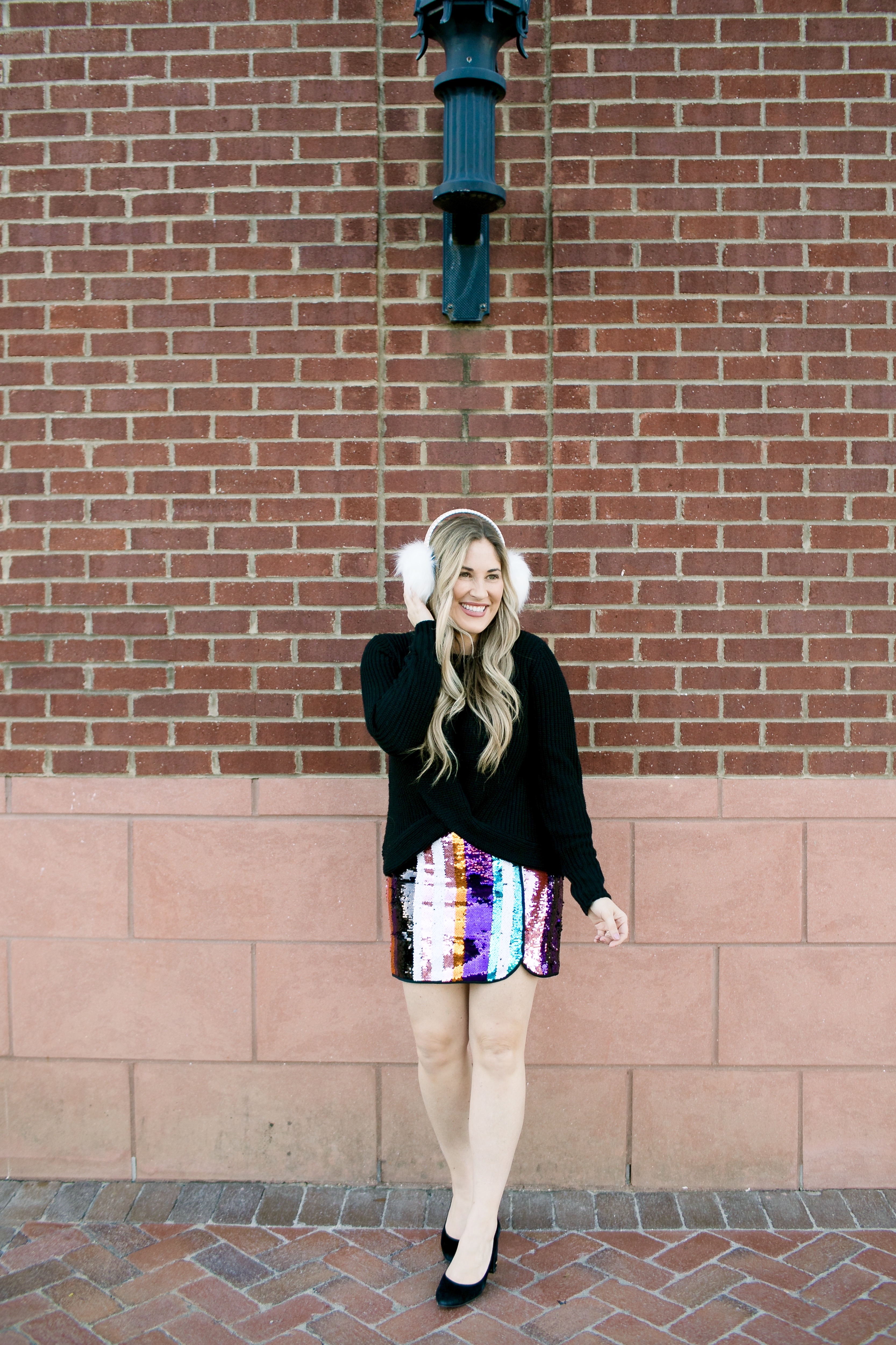 Holiday Style featured by top Memphis fashion blog, Walking in Memphis in High Heels: image of a woman wearing Francesca's sequin mini skirt,  Francesc's sweater, Francesca's furry ear muffs, and San Edelman pumps.