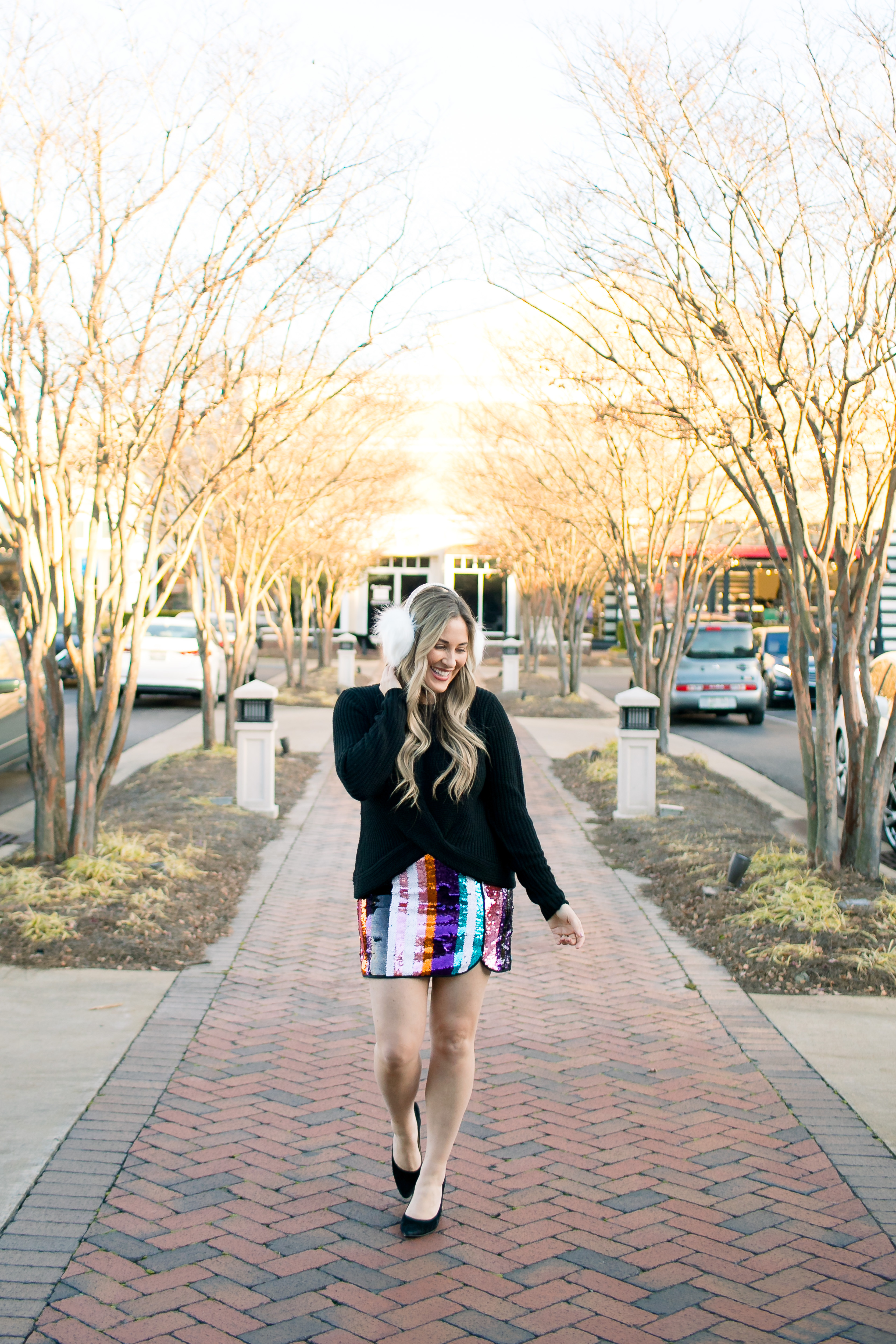 Holiday Style featured by top Memphis fashion blog, Walking in Memphis in High Heels: image of a woman wearing Francesca's sequin mini skirt,  Francesc's sweater, Francesca's furry ear muffs, and San Edelman pumps.