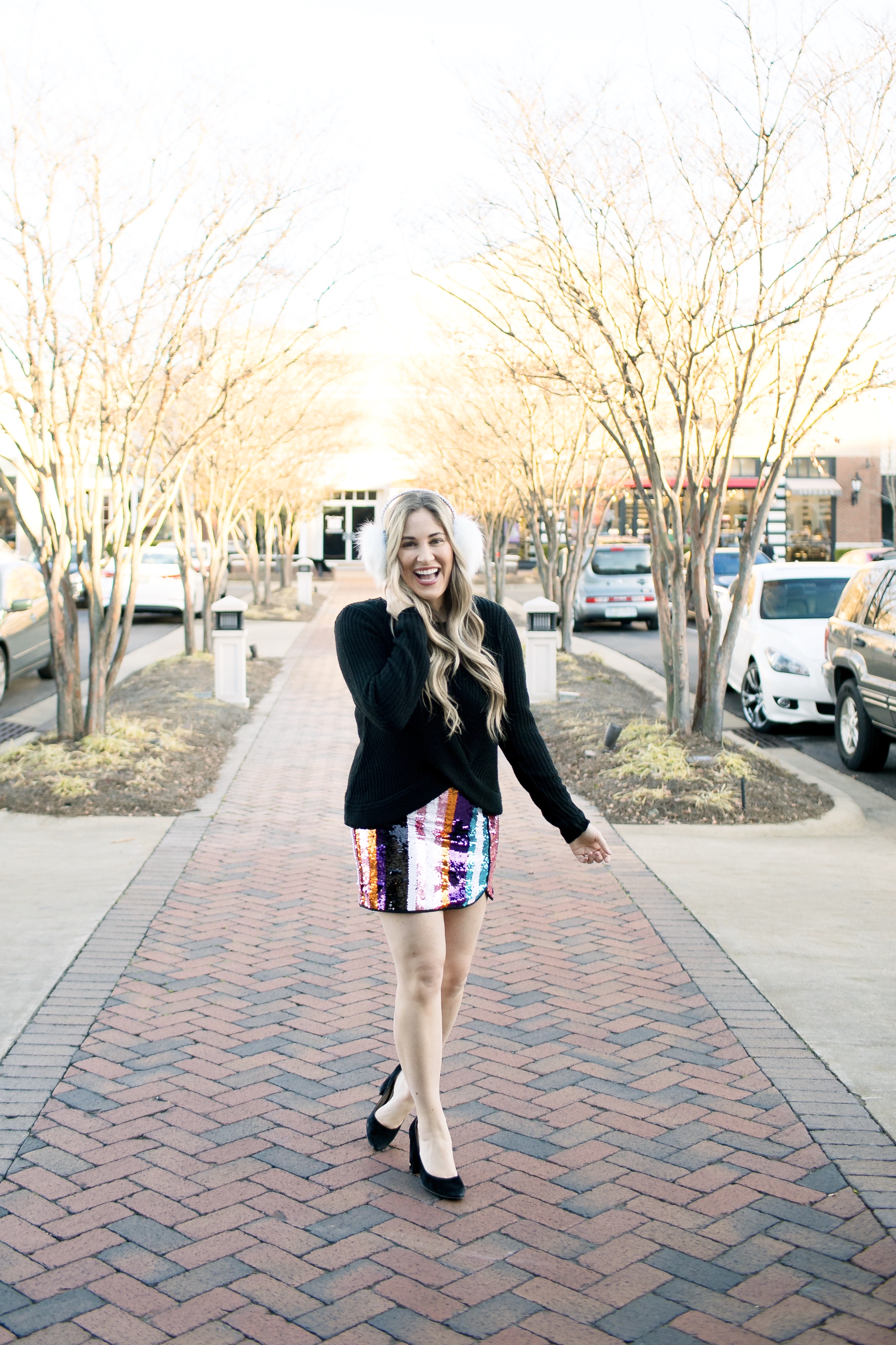 Holiday Style featured by top Memphis fashion blog, Walking in Memphis in High Heels: image of a woman wearing Francesca's sequin mini skirt,  Francesc's sweater, Francesca's furry ear muffs, and San Edelman pumps.