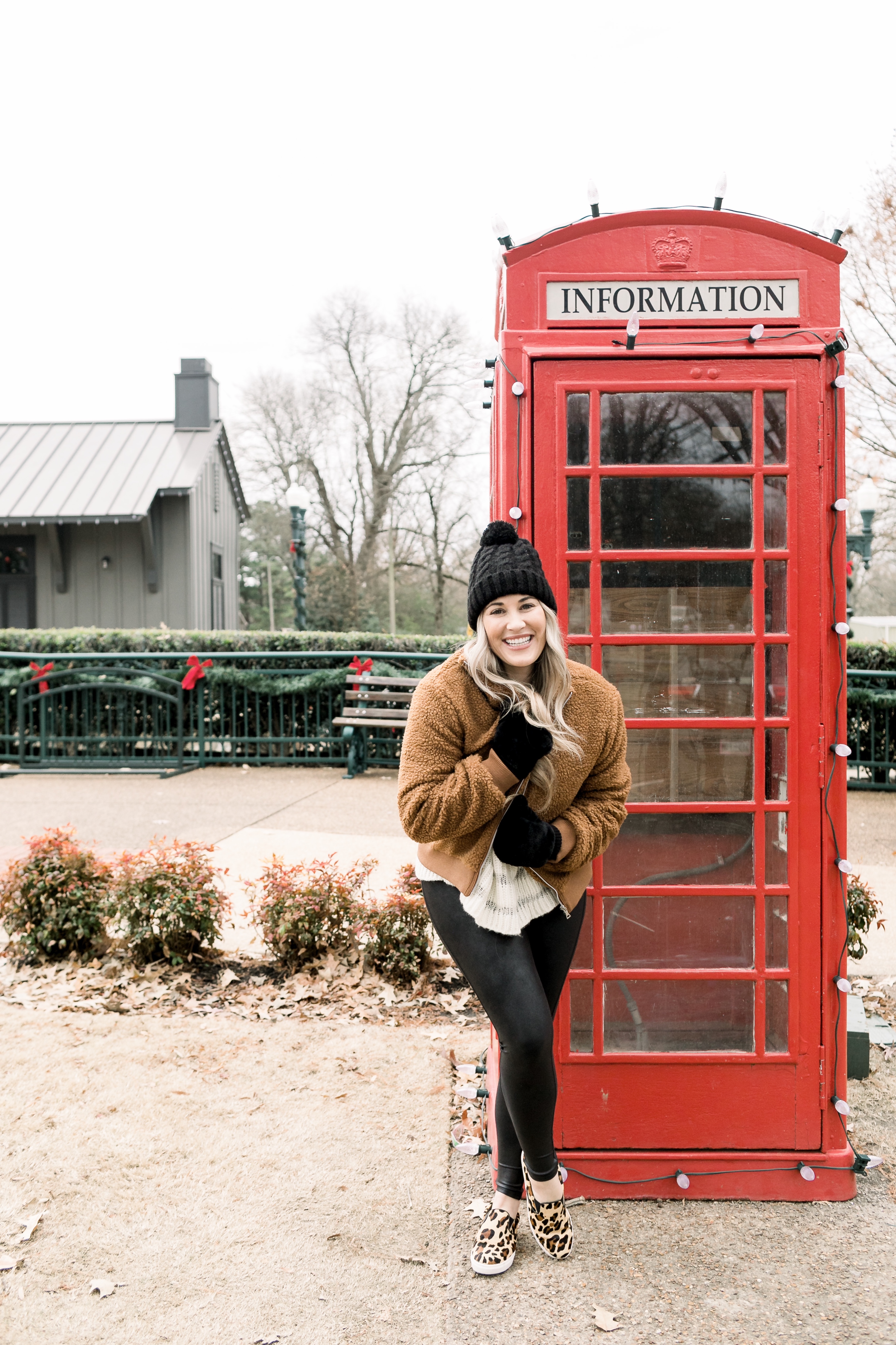 Cozy winter look styled by top US fashion blog, Walking in Memphis in High Heels: image of a woman wearing a Free People cropped sweater, New York Accessory Group pom beanie, Love + Joy teddy bear jacket, Kohl’s faux fur mittens, and Steve Madden leopard sneakers.