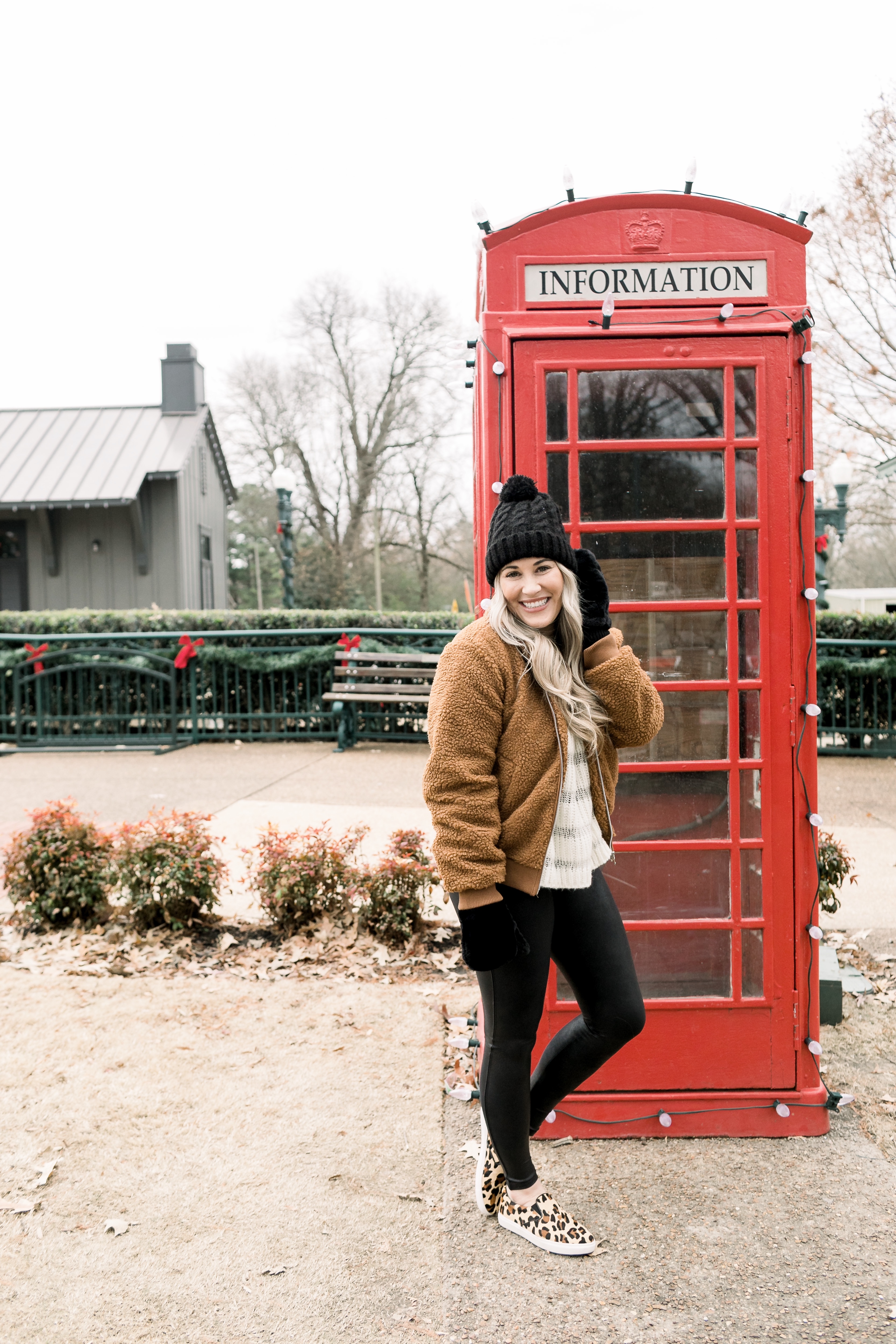 Cozy winter look styled by top US fashion blog, Walking in Memphis in High Heels: image of a woman wearing a Free People cropped sweater, New York Accessory Group pom beanie, Love + Joy teddy bear jacket, Kohl’s faux fur mittens, and Steve Madden leopard sneakers.