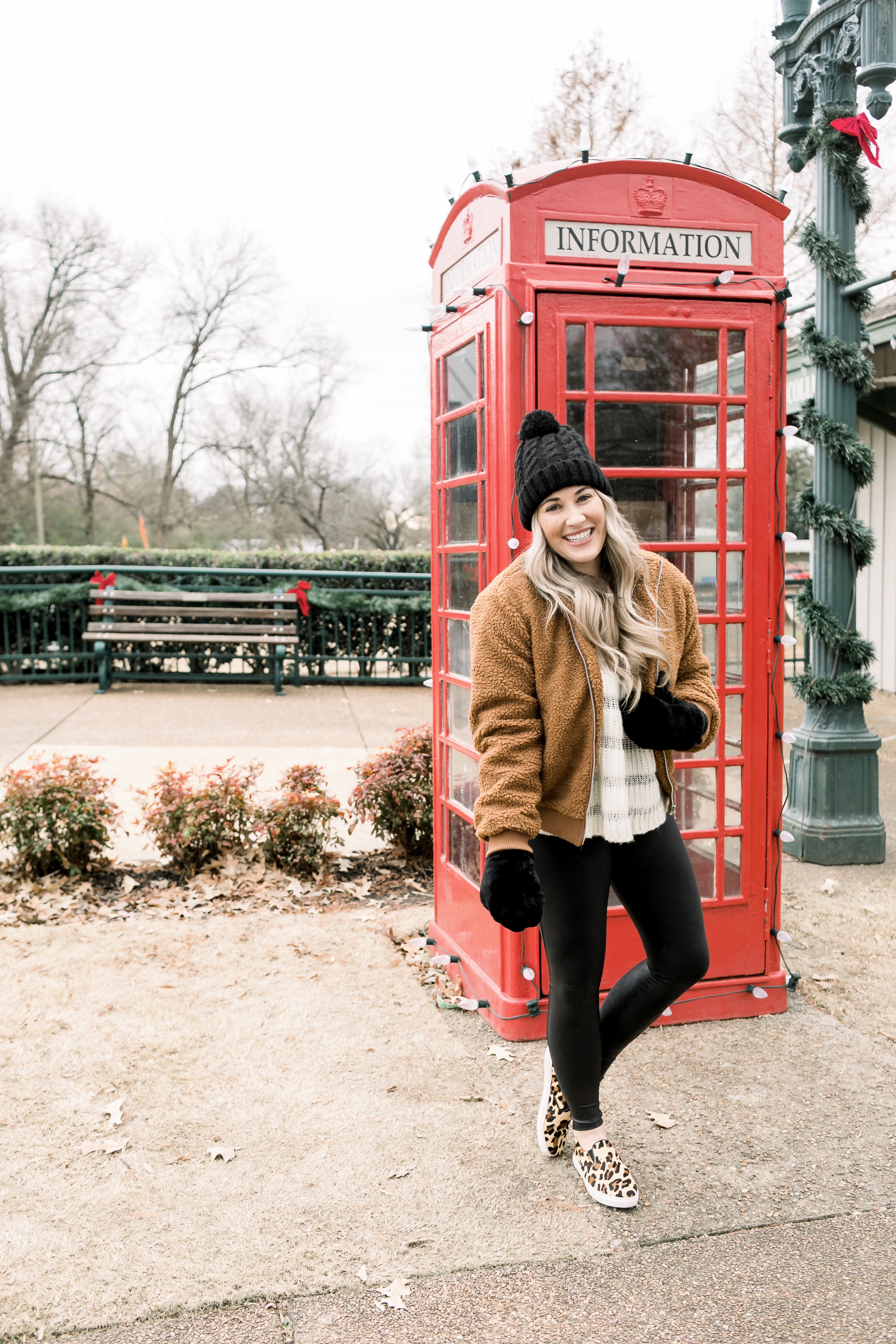 Cozy winter look styled by top US fashion blog, Walking in Memphis in High Heels: image of a woman wearing a Free People cropped sweater, New York Accessory Group pom beanie, Love + Joy teddy bear jacket, Kohl’s faux fur mittens, and Steve Madden leopard sneakers.