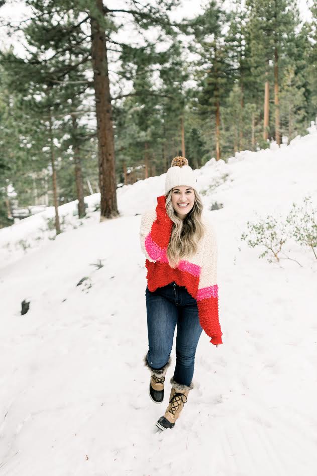 Cute winter sweaters featured by top Memphis fashion blog, Walking in Memphis in High Heels: image of a woman wearing a Woven Heart striped sweater.