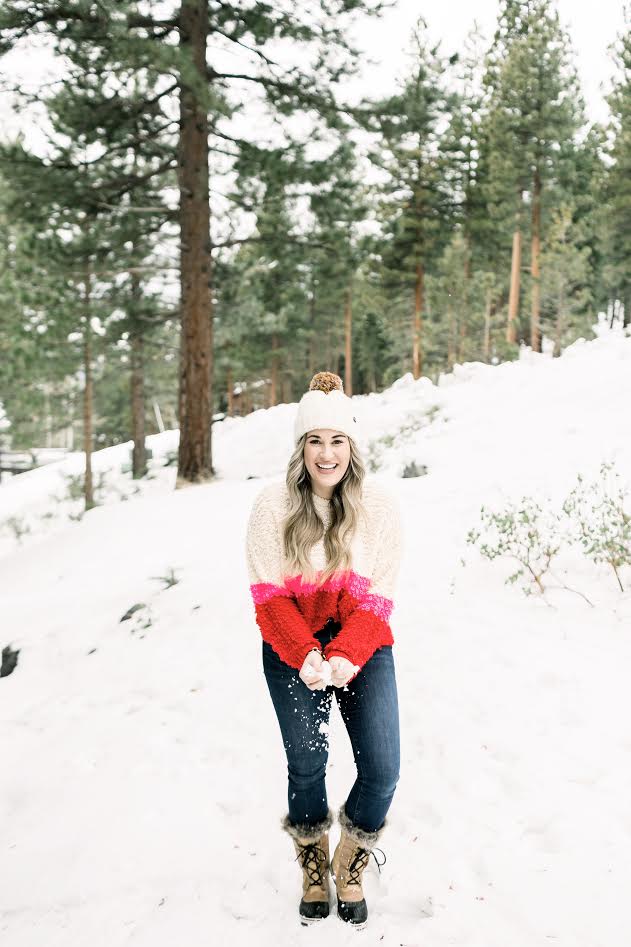 Cute winter sweaters featured by top Memphis fashion blog, Walking in Memphis in High Heels: image of a woman wearing a Woven Heart striped sweater.