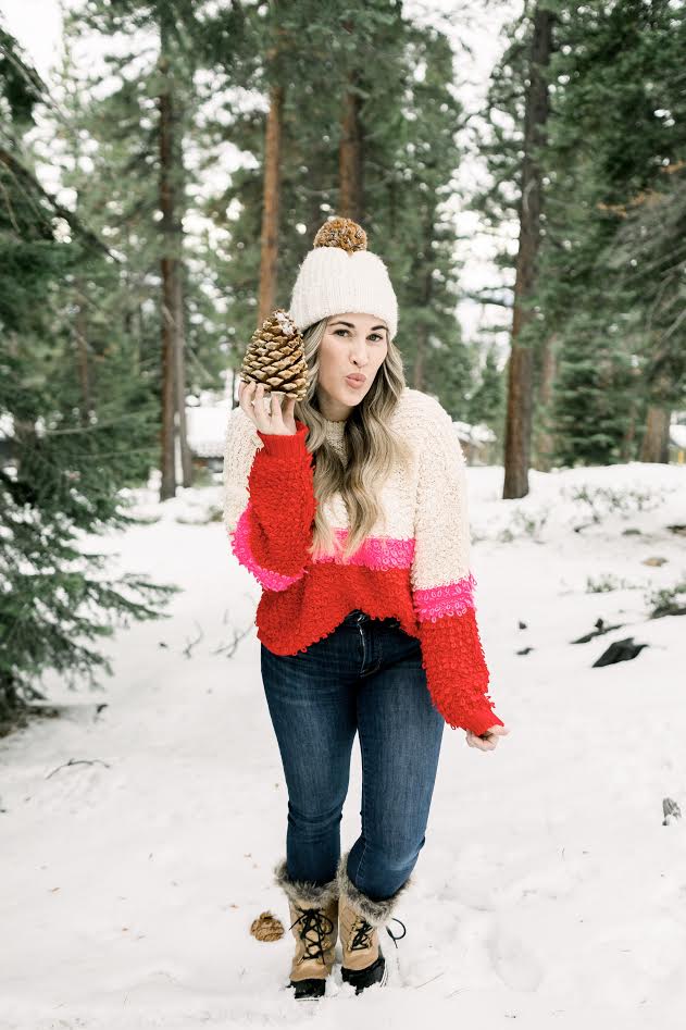 Cute winter sweaters featured by top Memphis fashion blog, Walking in Memphis in High Heels: image of a woman wearing a Woven Heart striped sweater.