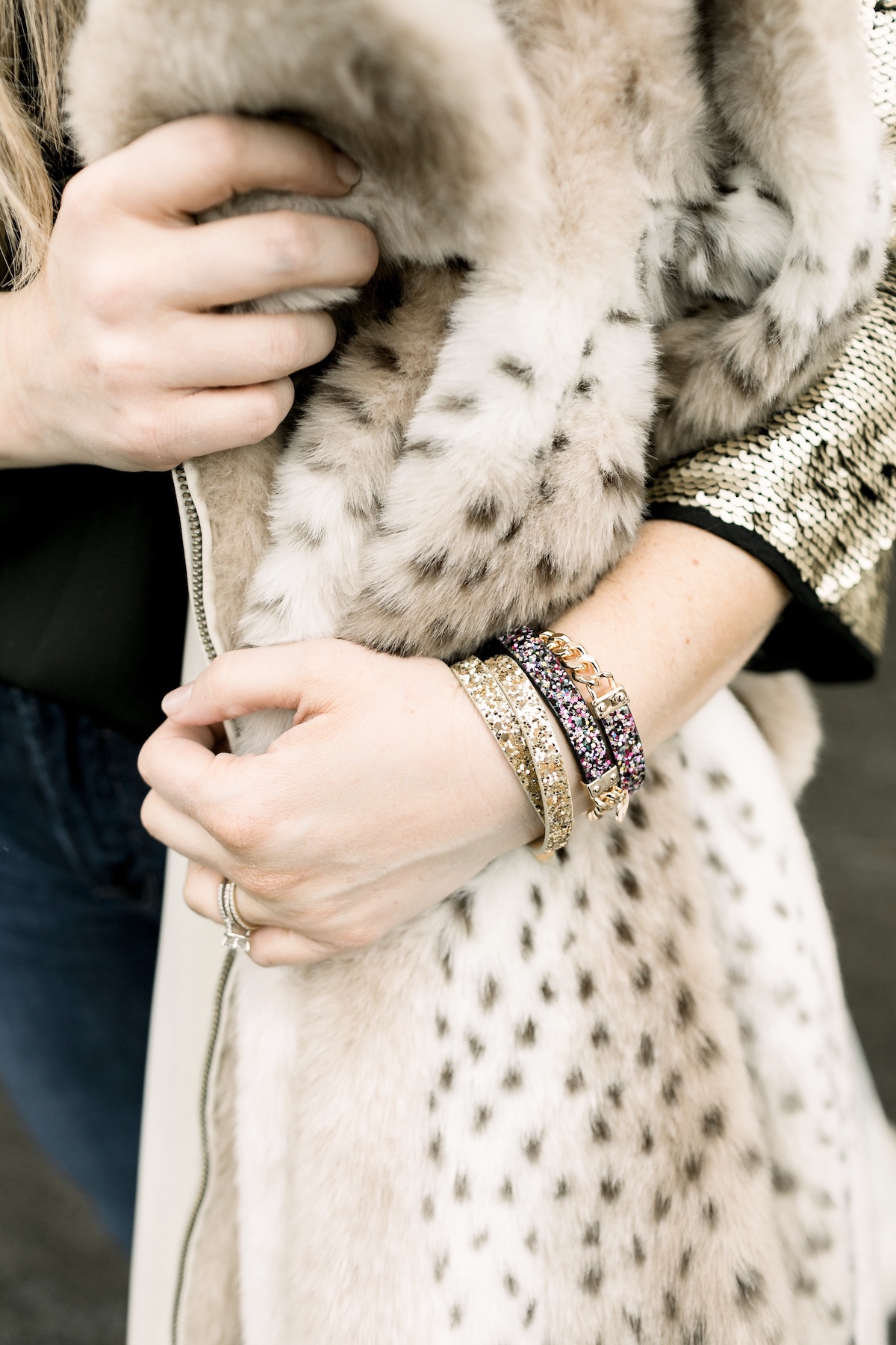 Winter Essentials featured by top Memphis fashion blog, Walking in Memphis in High Heels: image of a woman wearing an ARIAT top, Dennis Basso leopard faux fur coat, Good American high rise skinny jeans, Enzo Angiolini booties, and Surell earmuffs.