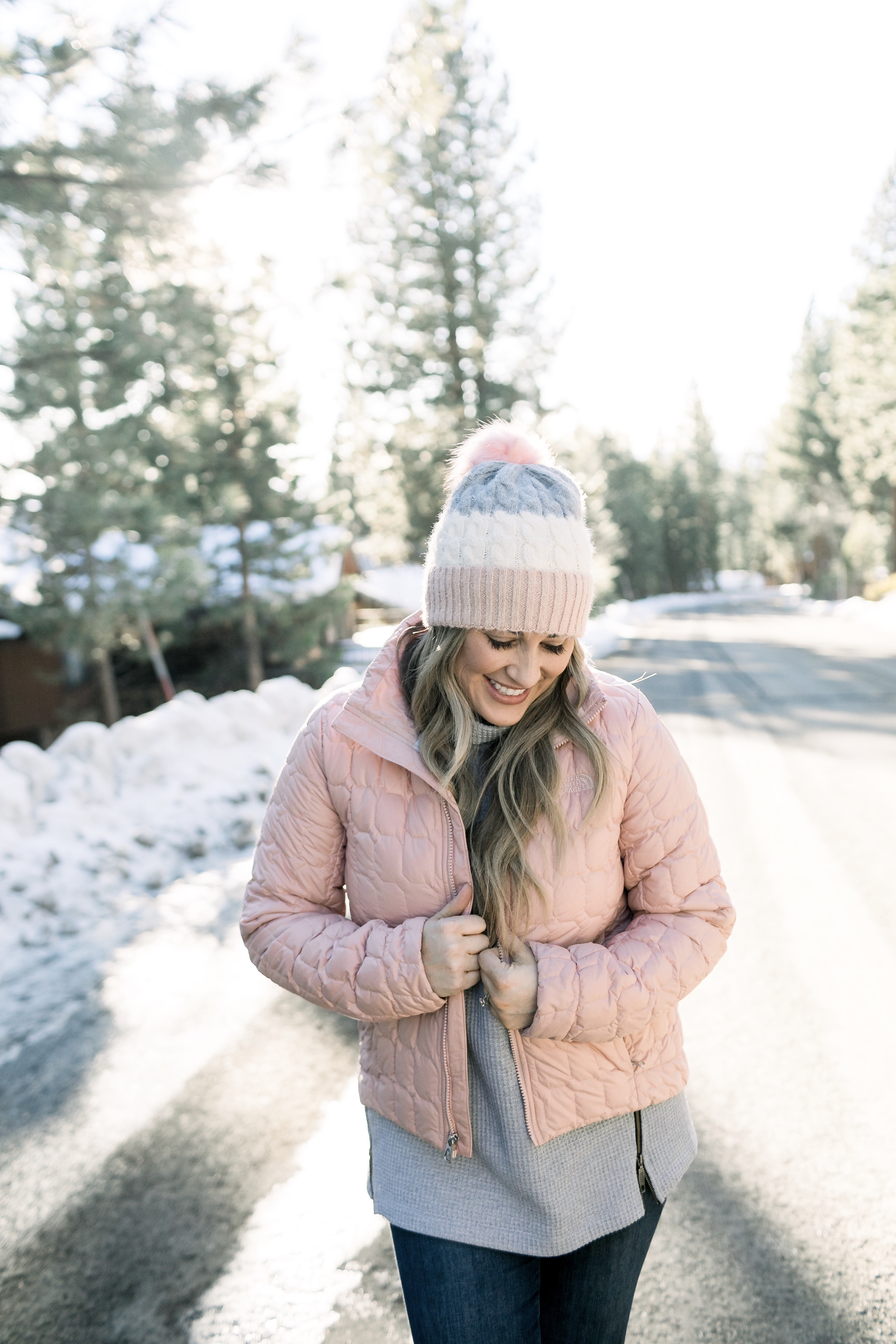 How to Wear Pastels in the Winter, fashion tips featured by top Memphis blog, Walking in Memphis in High Heels: image of a woman wearing a light pink The North Face crop jacket, ASOS blush pom beanie, Sorel blush snow boots.