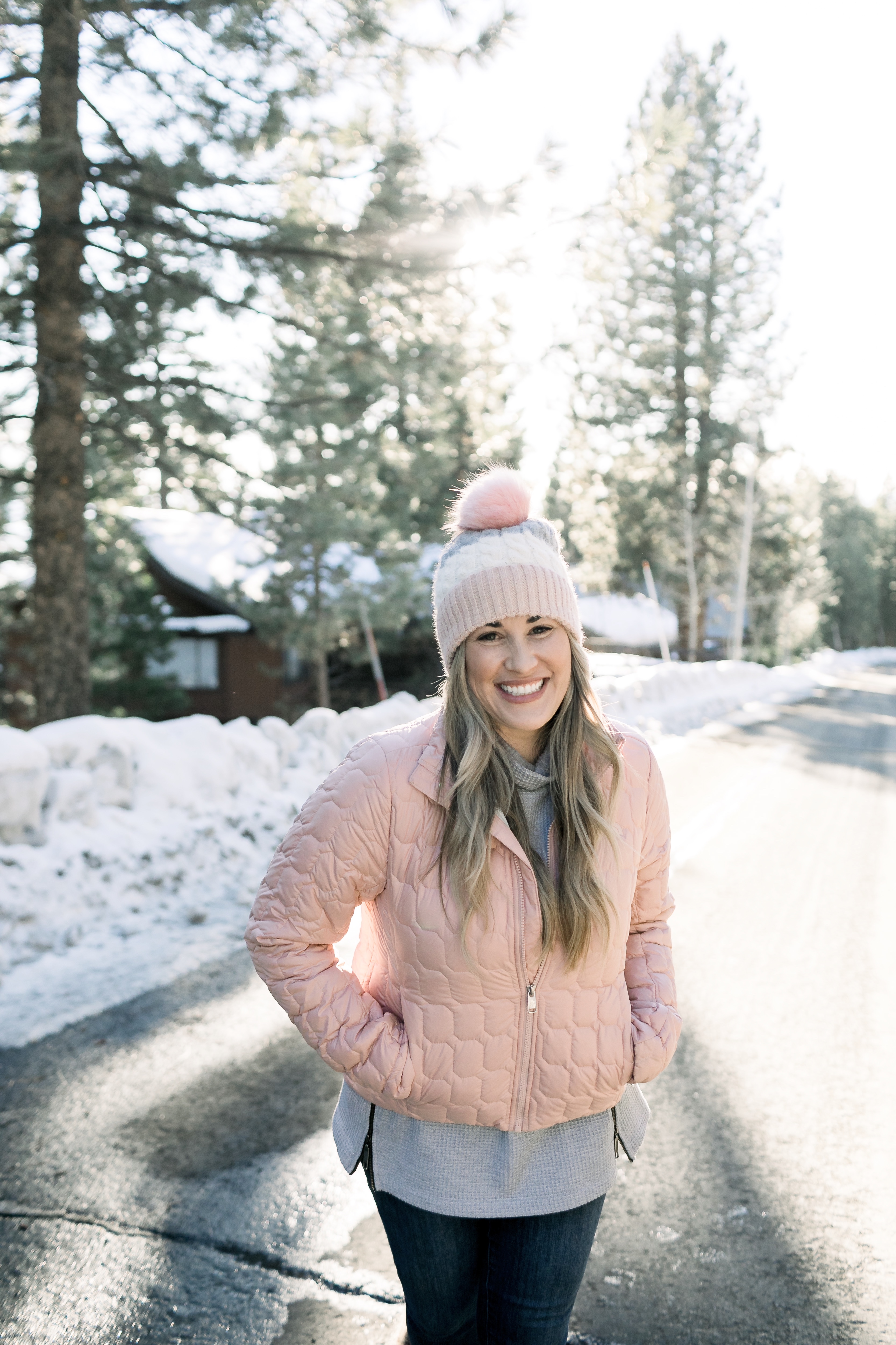 How to Wear Pastels in the Winter, fashion tips featured by top Memphis blog, Walking in Memphis in High Heels: image of a woman wearing a light pink The North Face crop jacket, ASOS blush pom beanie, Sorel blush snow boots.