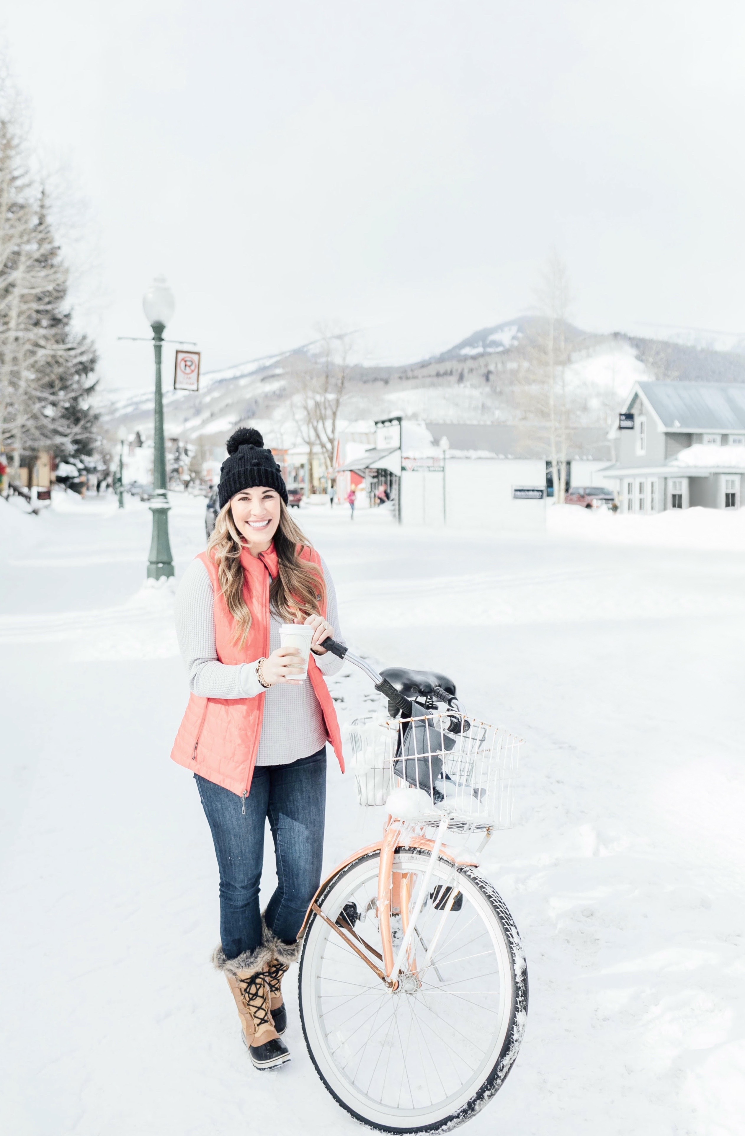 Winter layers styled by top Memphis fashion blog, Walking in Memphis in High Heels: image of a woman wearing a Patagonia insulated vest, TheNorthFace long sleeve waffle top, Good American high waisted jeans, TheNorthFace pom pom beanie, Sorel Tofino II Boots, and Smartwool flurry socks.