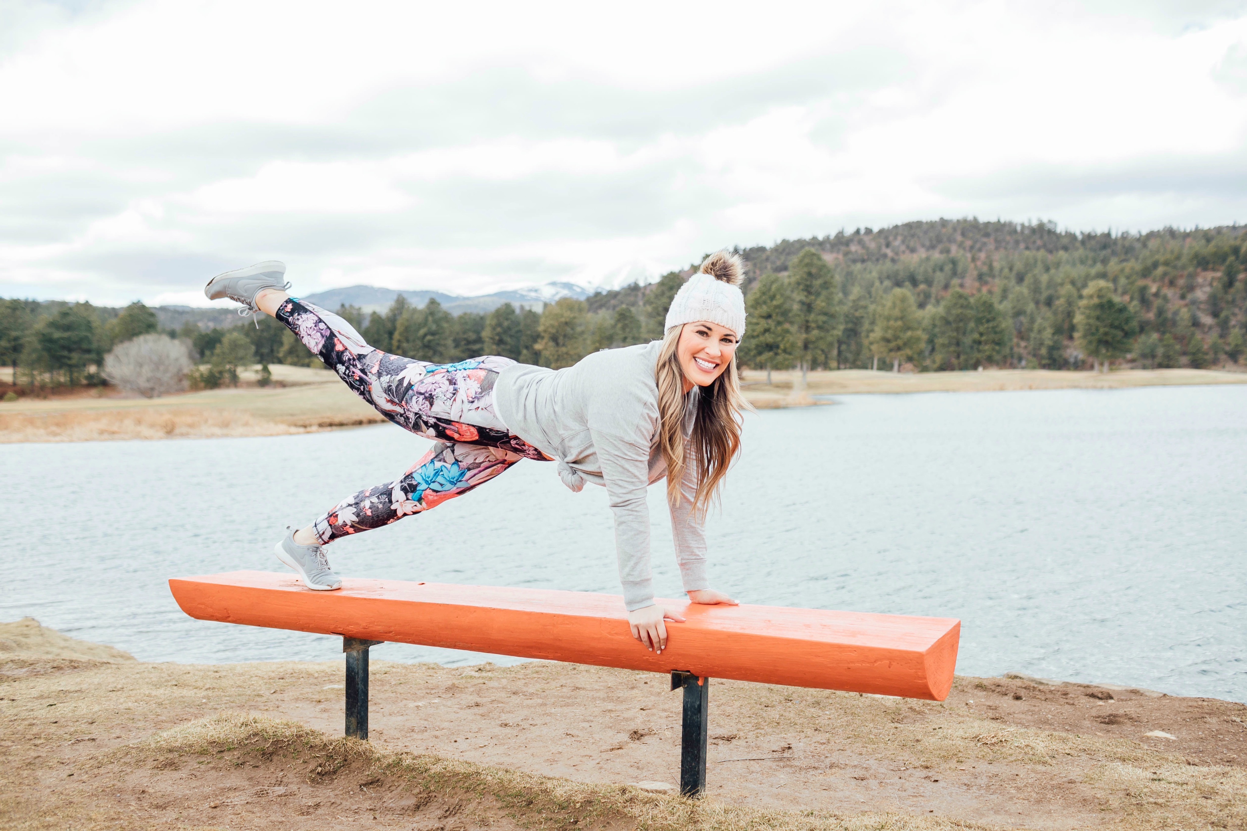 spring athleisure featured by top Memphis fashion and fitness blog, Walking in Memphis in High Heels: image of a woman Wearing CALIA by Carrie Underwood printed leggings, printed sports bra, keyhole sweater, Adidas originals run shoes