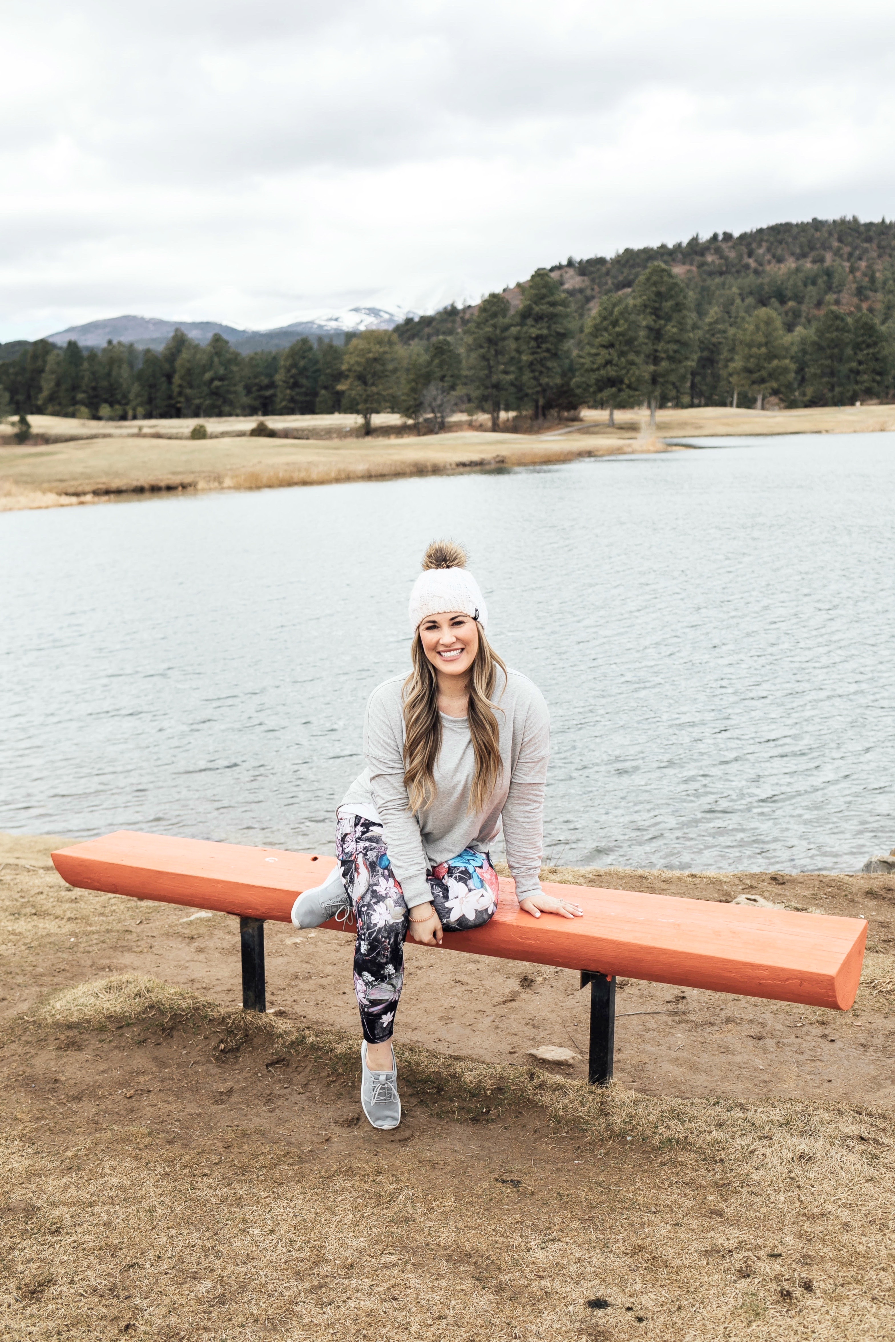 spring athleisure featured by top Memphis fashion and fitness blog, Walking in Memphis in High Heels: image of a woman Wearing CALIA by Carrie Underwood printed leggings, printed sports bra, keyhole sweater, Adidas originals run shoes