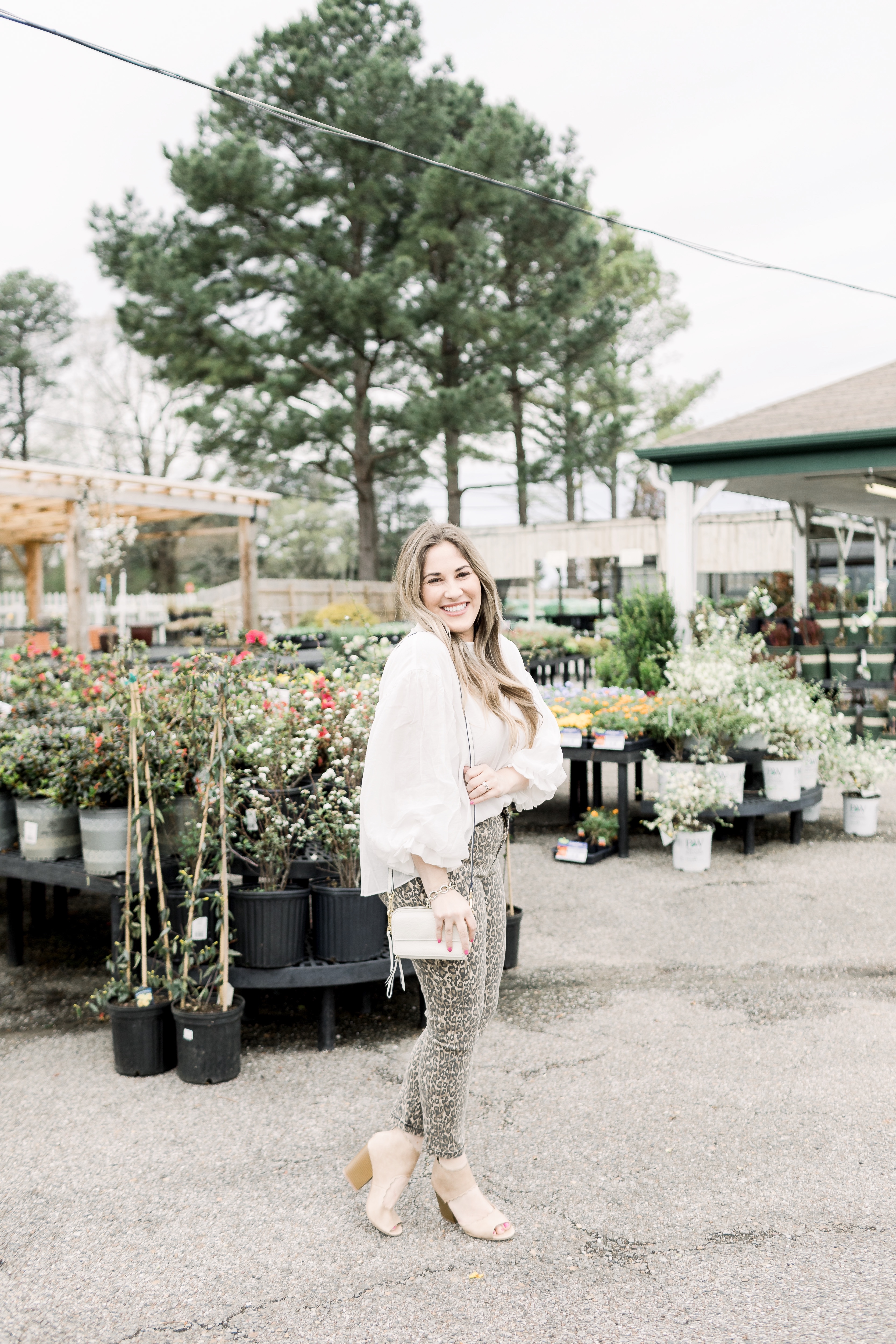 Spring prints featured by top Memphis fashion blog, Walking in Memphis in High Heels: image of a woman wearing Cisono skinny leopard pants, Red Dress Boutique whimsy top, and Sam Edelman sandal heels.