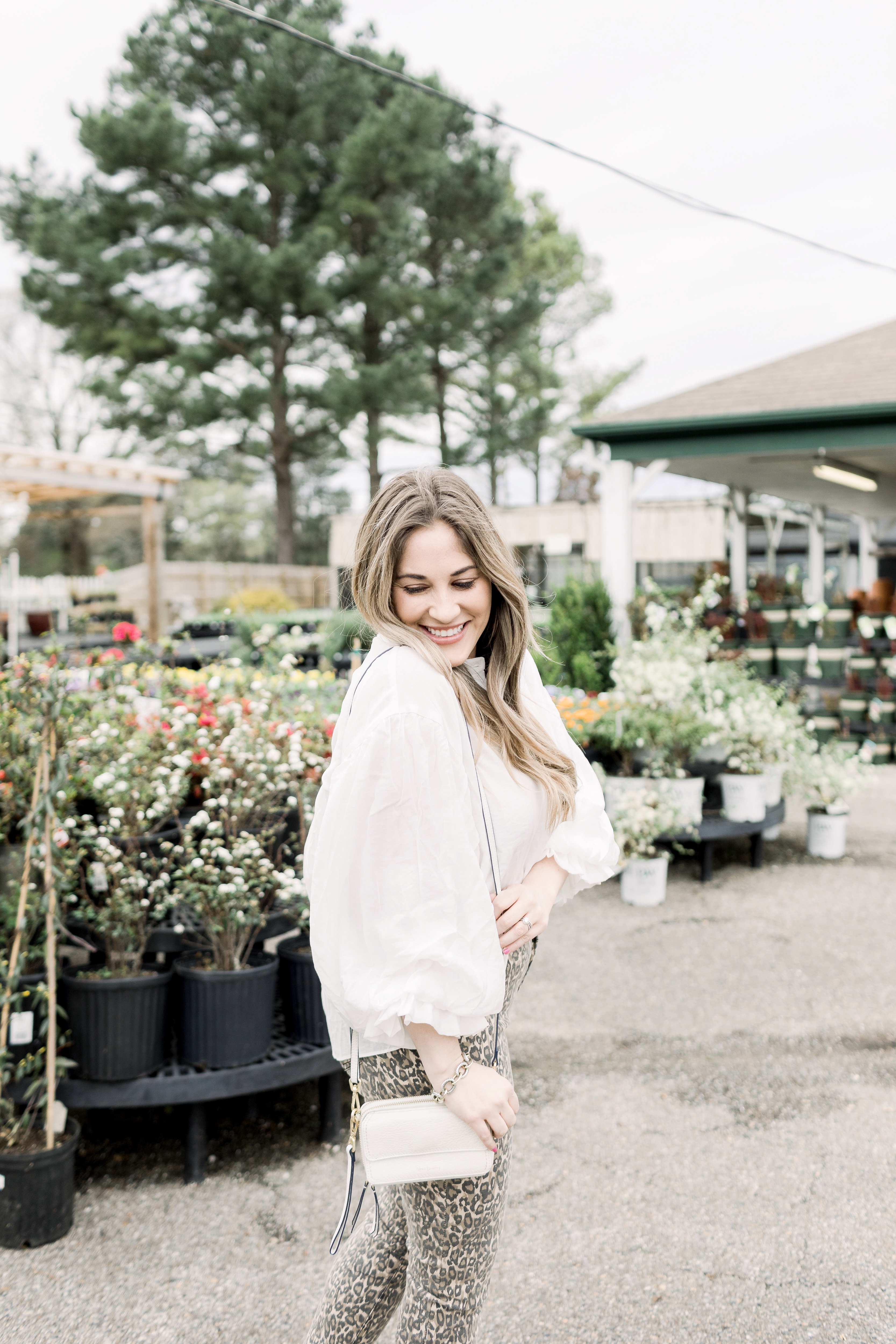 Spring prints featured by top Memphis fashion blog, Walking in Memphis in High Heels: image of a woman wearing Cisono skinny leopard pants, Red Dress Boutique whimsy top, and Sam Edelman sandal heels.