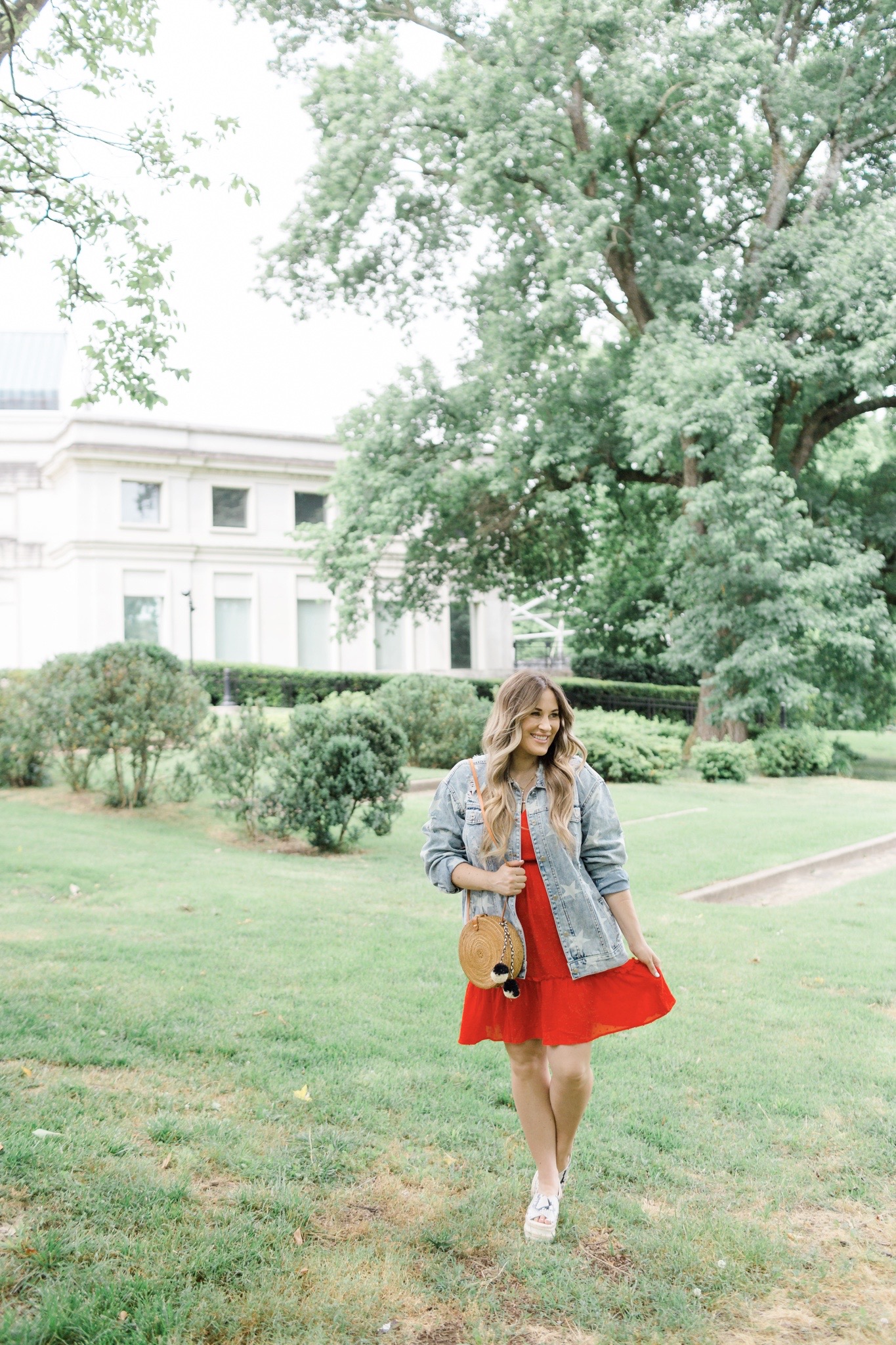 Patriotic Apparel featured by top Memphis fashion blogger, Walking in Memphis in High Heels: image of a pregnant woman wearing a North & Main red dress, North & Main star denim jacket, snake print espadrille wedge sandals, and a Baublebar initial pendant.