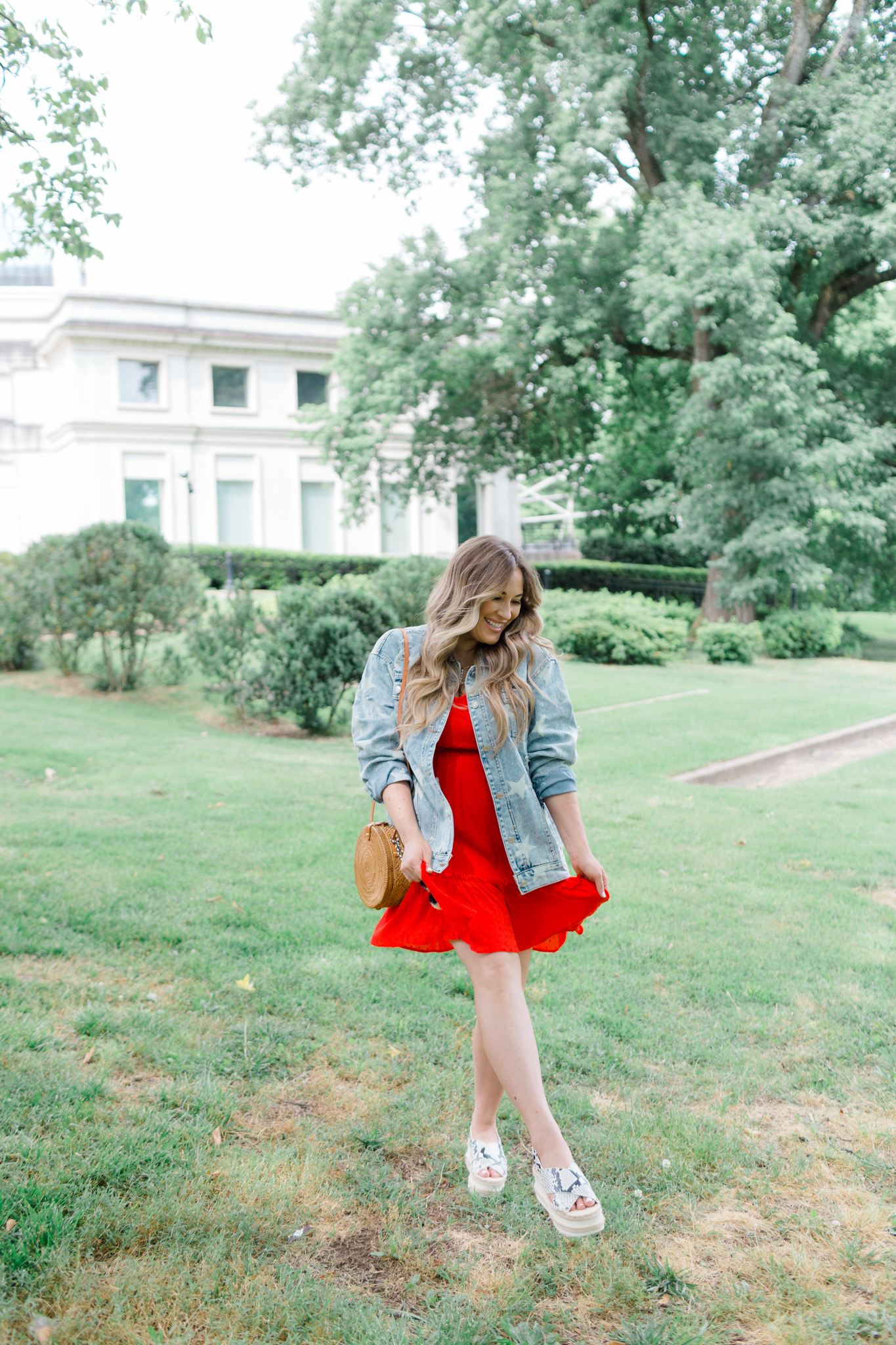 Patriotic Apparel featured by top Memphis fashion blogger, Walking in Memphis in High Heels: image of a pregnant woman wearing a North & Main red dress, North & Main star denim jacket, snake print espadrille wedge sandals, and a Baublebar initial pendant.