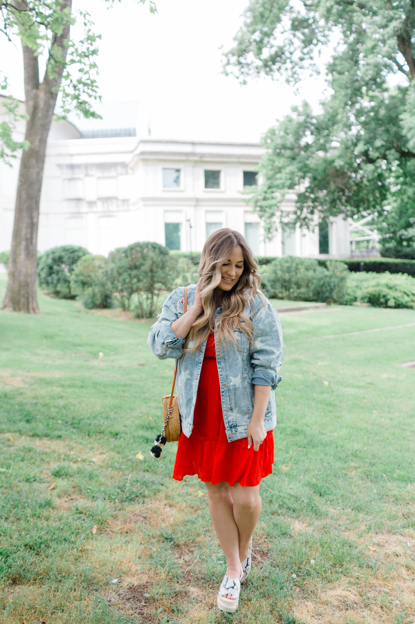 Patriotic Apparel featured by top Memphis fashion blogger, Walking in Memphis in High Heels: image of a pregnant woman wearing a North & Main red dress, North & Main star denim jacket, snake print espadrille wedge sandals, and a Baublebar initial pendant.