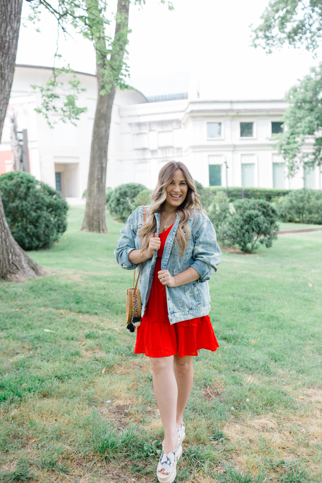 Patriotic Apparel featured by top Memphis fashion blogger, Walking in Memphis in High Heels: image of a pregnant woman wearing a North & Main red dress, North & Main star denim jacket, snake print espadrille wedge sandals, and a Baublebar initial pendant.