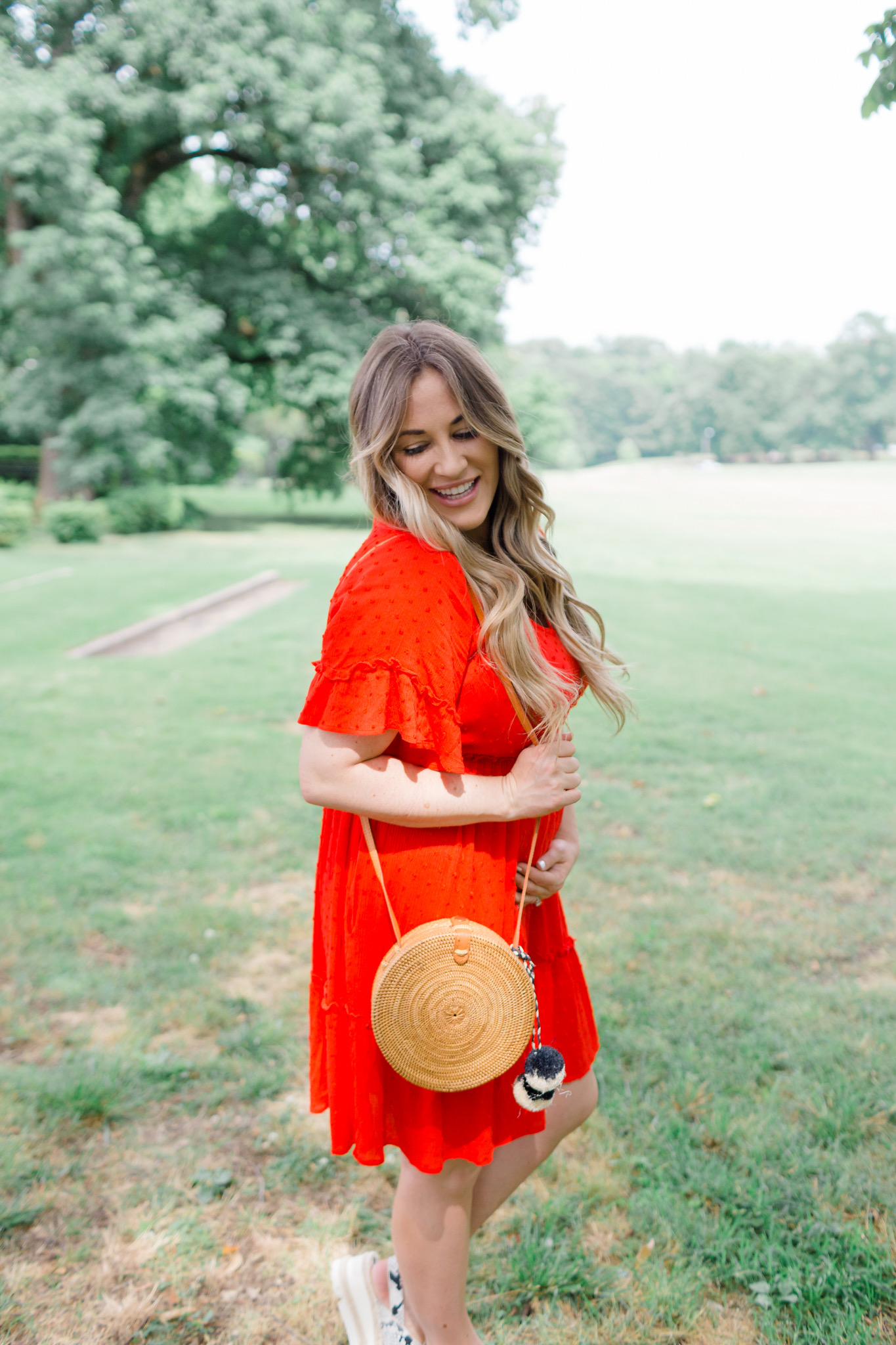 Patriotic Apparel featured by top Memphis fashion blogger, Walking in Memphis in High Heels: image of a pregnant woman wearing a North & Main red dress, North & Main star denim jacket, snake print espadrille wedge sandals, and a Baublebar initial pendant.