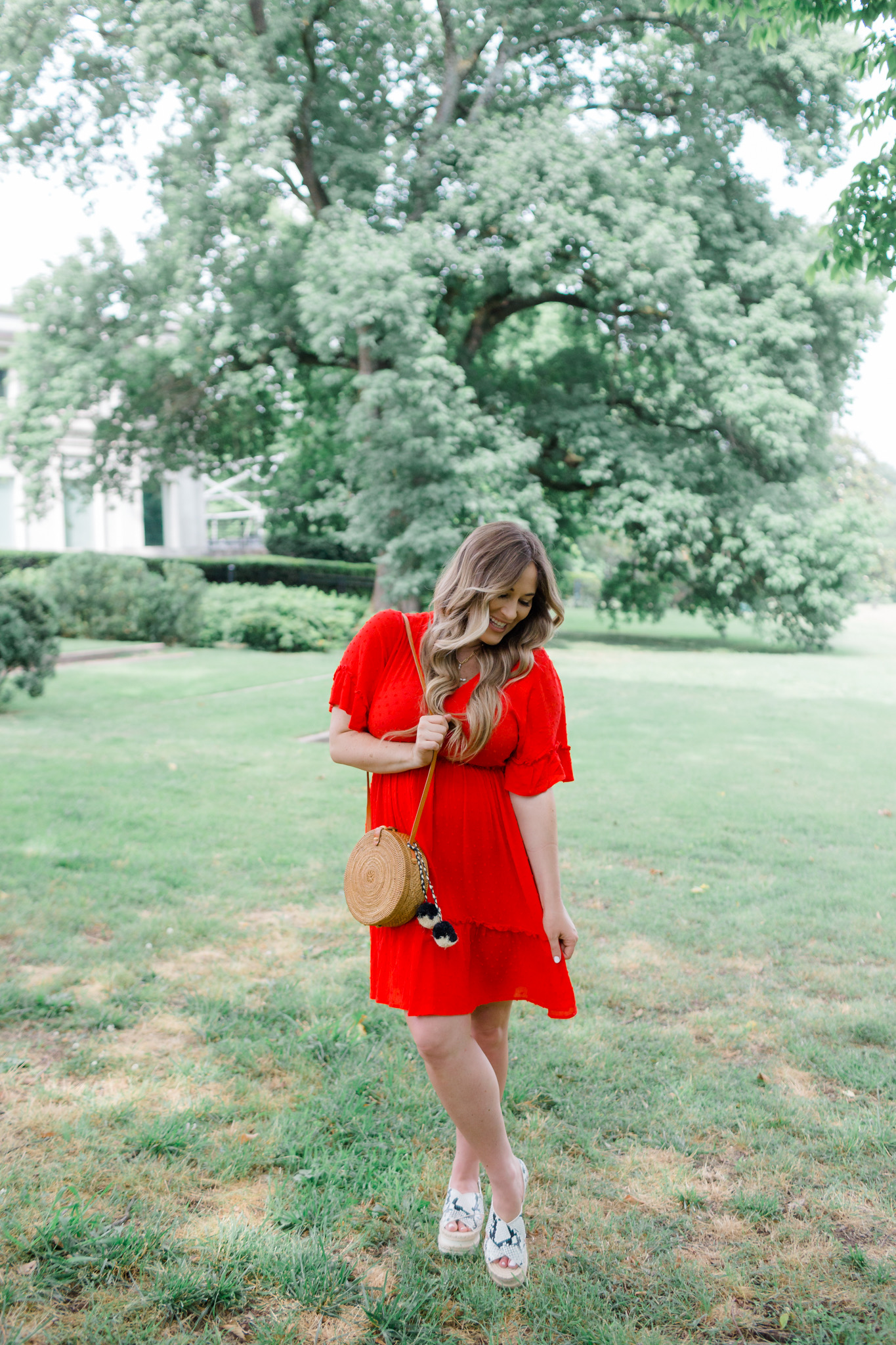 Patriotic Apparel featured by top Memphis fashion blogger, Walking in Memphis in High Heels: image of a pregnant woman wearing a North & Main red dress, North & Main star denim jacket, snake print espadrille wedge sandals, and a Baublebar initial pendant.