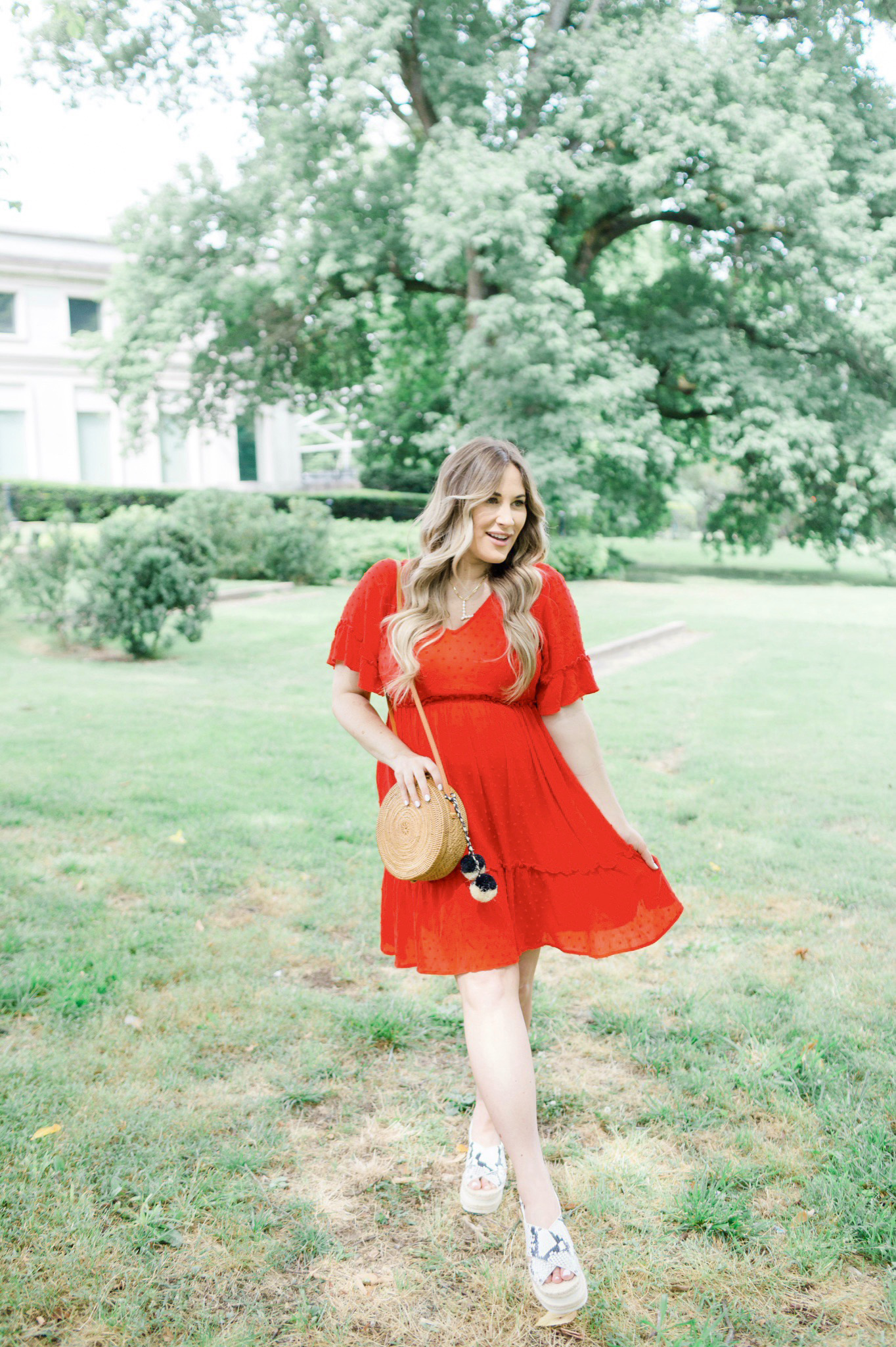 Patriotic Apparel featured by top Memphis fashion blogger, Walking in Memphis in High Heels: image of a pregnant woman wearing a North & Main red dress, North & Main star denim jacket, snake print espadrille wedge sandals, and a Baublebar initial pendant.