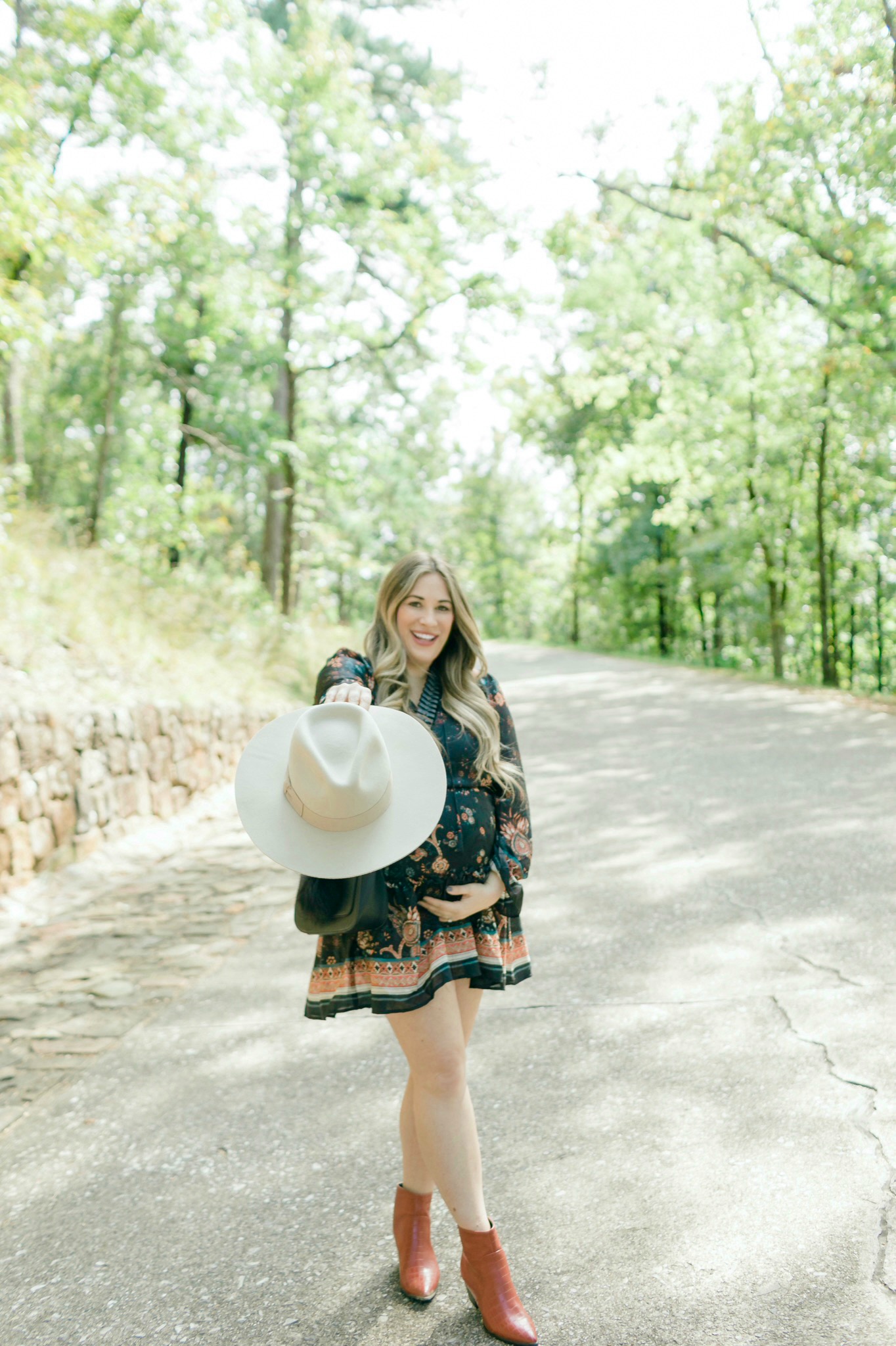 Cute Thanksgiving looks featured by top Memphis fashion blogger, Walking in Memphis in High Heels> image of a pregnant woman wearing a Red Dress floral dress, a Red Dress panama hat, Red Dress brown booties.