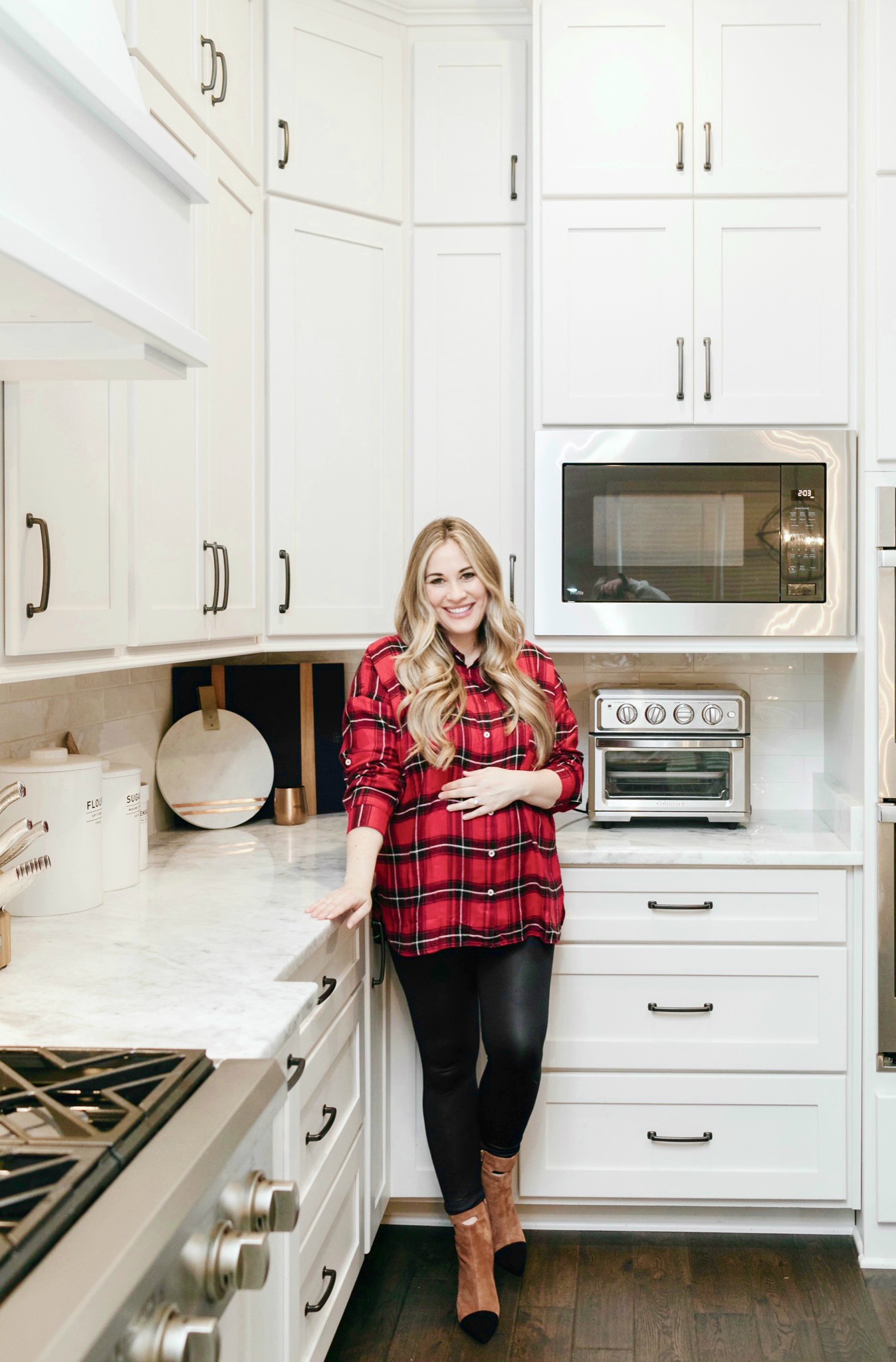 Cozy Maternity Winter Look styled by top Memphis fashion blogger, Walking in Memphis in High Heels: image of a pregnant woman wearing a  Mud Pie tartan flannel shirt, SPANX faux leather leggings and 42 GOLD booties