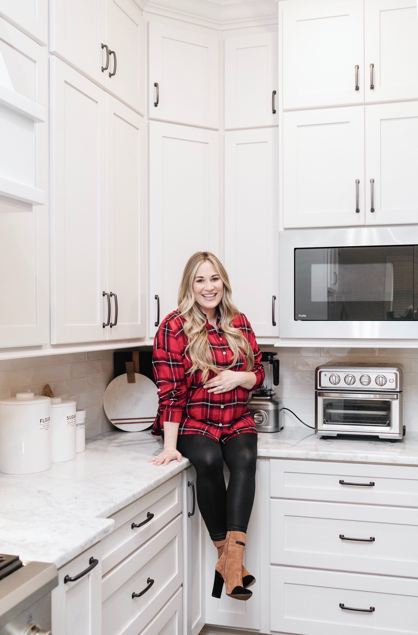 Cozy Maternity Winter Look styled by top Memphis fashion blogger, Walking in Memphis in High Heels: image of a pregnant woman wearing a  Mud Pie tartan flannel shirt, SPANX faux leather leggings and 42 GOLD booties