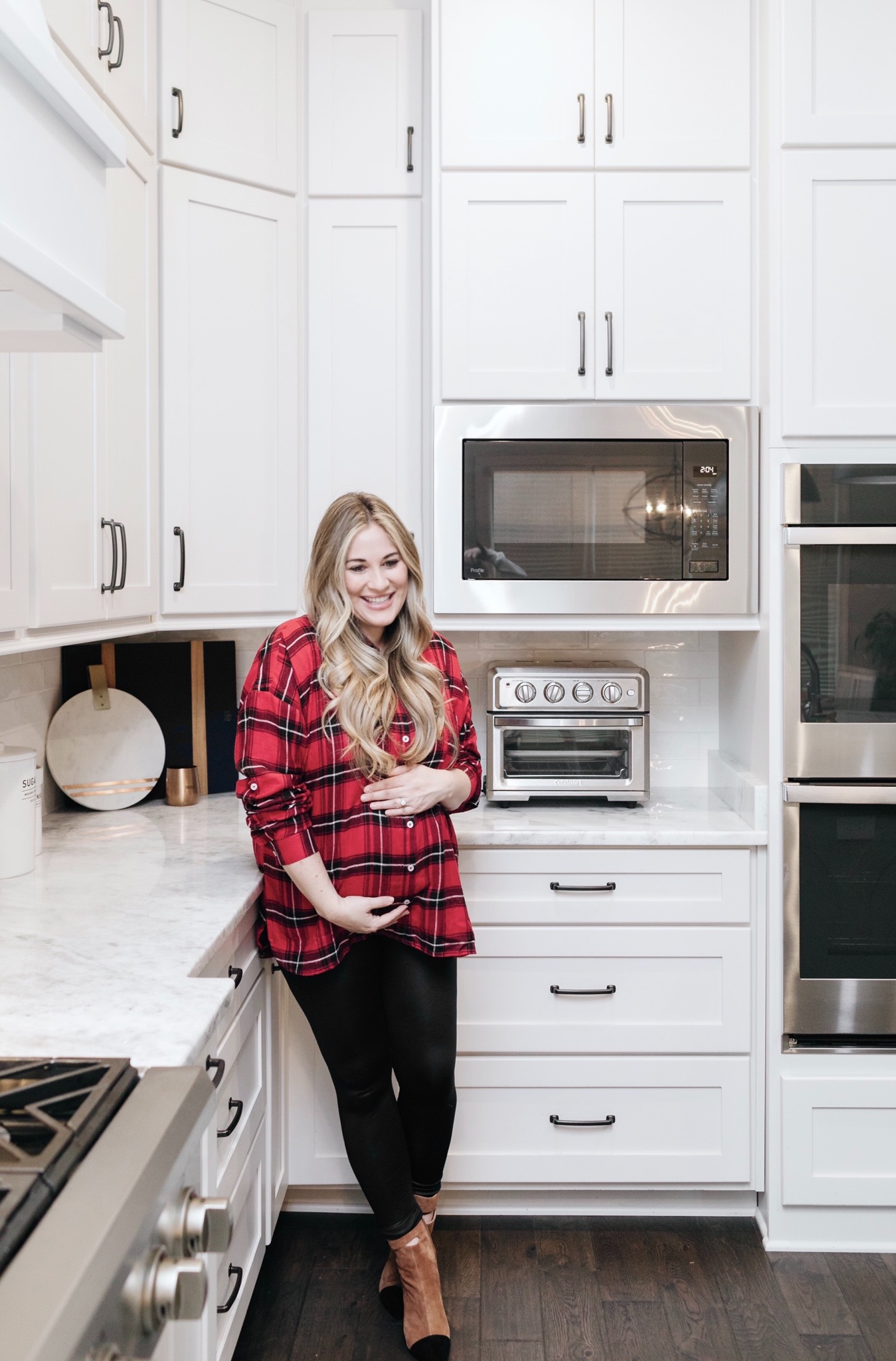 Cozy Maternity Winter Look styled by top Memphis fashion blogger, Walking in Memphis in High Heels: image of a pregnant woman wearing a  Mud Pie tartan flannel shirt, SPANX faux leather leggings and 42 GOLD booties