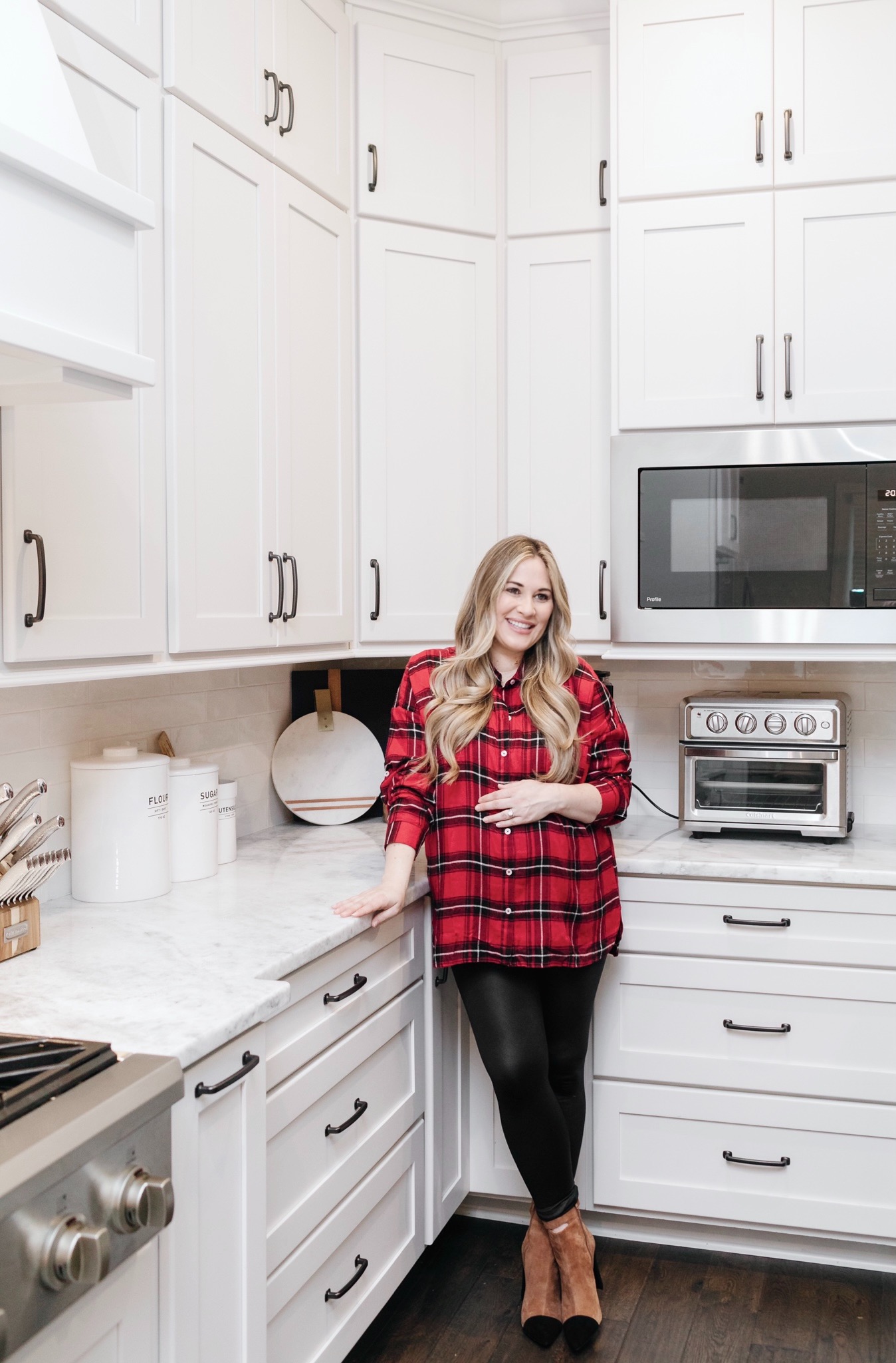 Cozy Maternity Winter Look styled by top Memphis fashion blogger, Walking in Memphis in High Heels: image of a pregnant woman wearing a  Mud Pie tartan flannel shirt, SPANX faux leather leggings and 42 GOLD booties