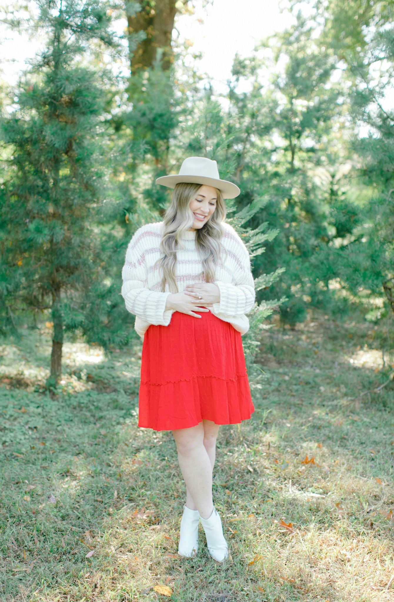 Cute Christmas Look featured by top Memphis fashion blogger, Walking in Memphis in High Heels: image of a pregnant woman wearing a Mint Julep red sing dress, Lulus knit sweater, Brixton hat and Marc Fisher white booties.