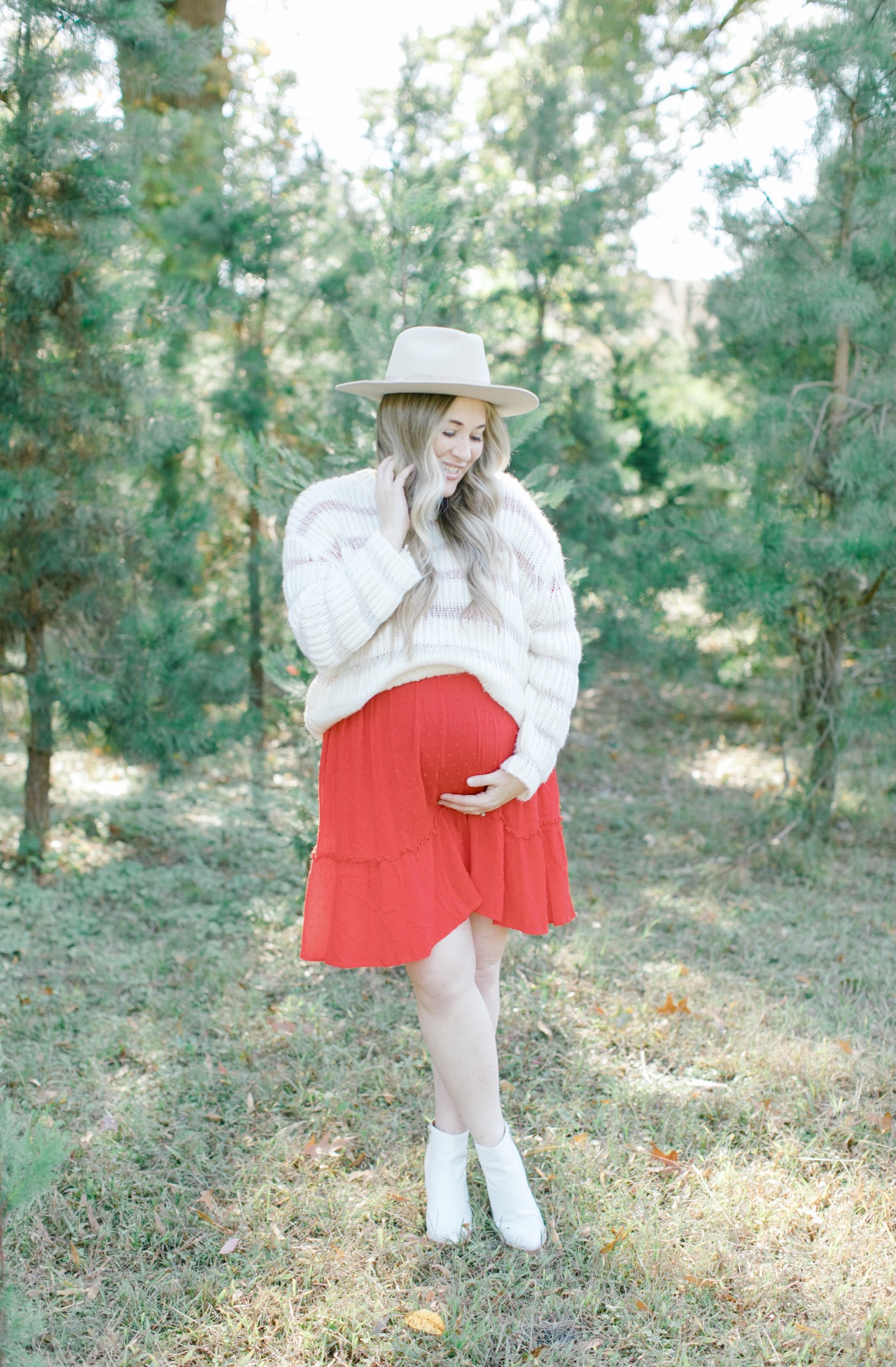 Cute Christmas Look featured by top Memphis fashion blogger, Walking in Memphis in High Heels: image of a pregnant woman wearing a Mint Julep red sing dress, Lulus knit sweater, Brixton hat and Marc Fisher white booties.