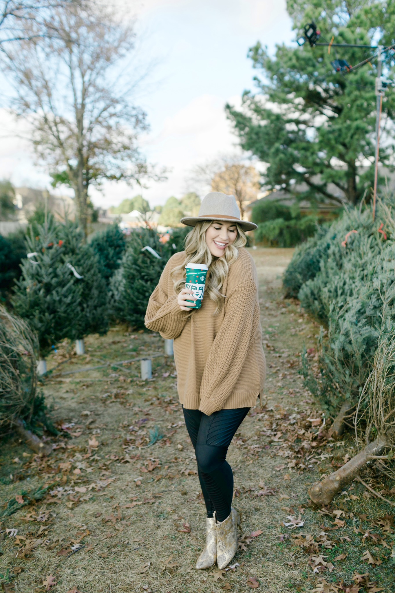 How to Wear a Sweater with Leggings, tips featured by top Memphis fashion blogger, Walking in Memphis in High Heels: image of a woman wearing Red Dress Camel Sweater and SPANX faux leather motto leggings