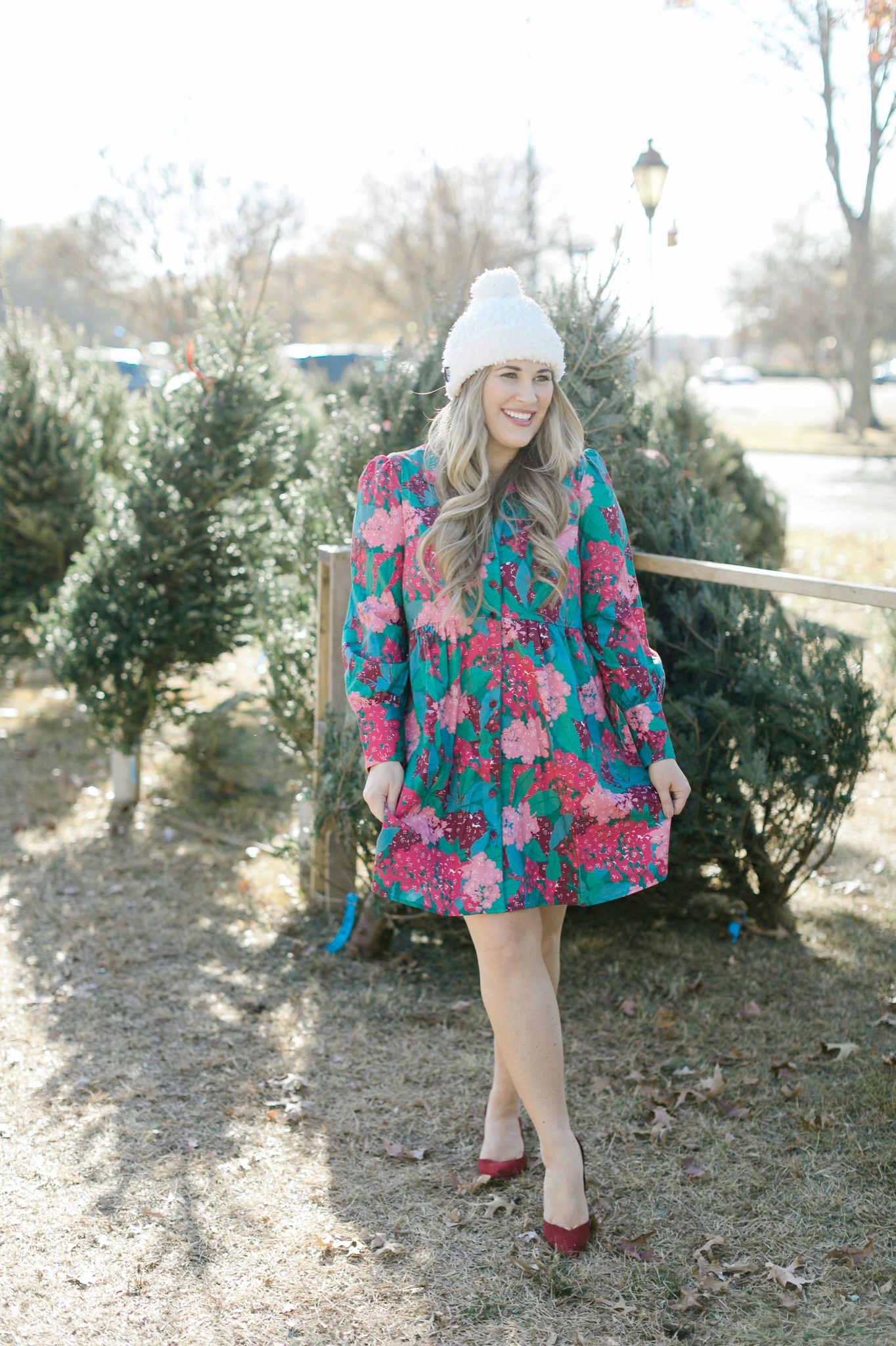 Winter floral look styled by top Memphis fashion blogger, Walking in Memphis in High Heels: image of a woman wearing a Tuckernuck floral shirt dress, Vince Camuto Selindra pumps and MUK LUKS pom hat.