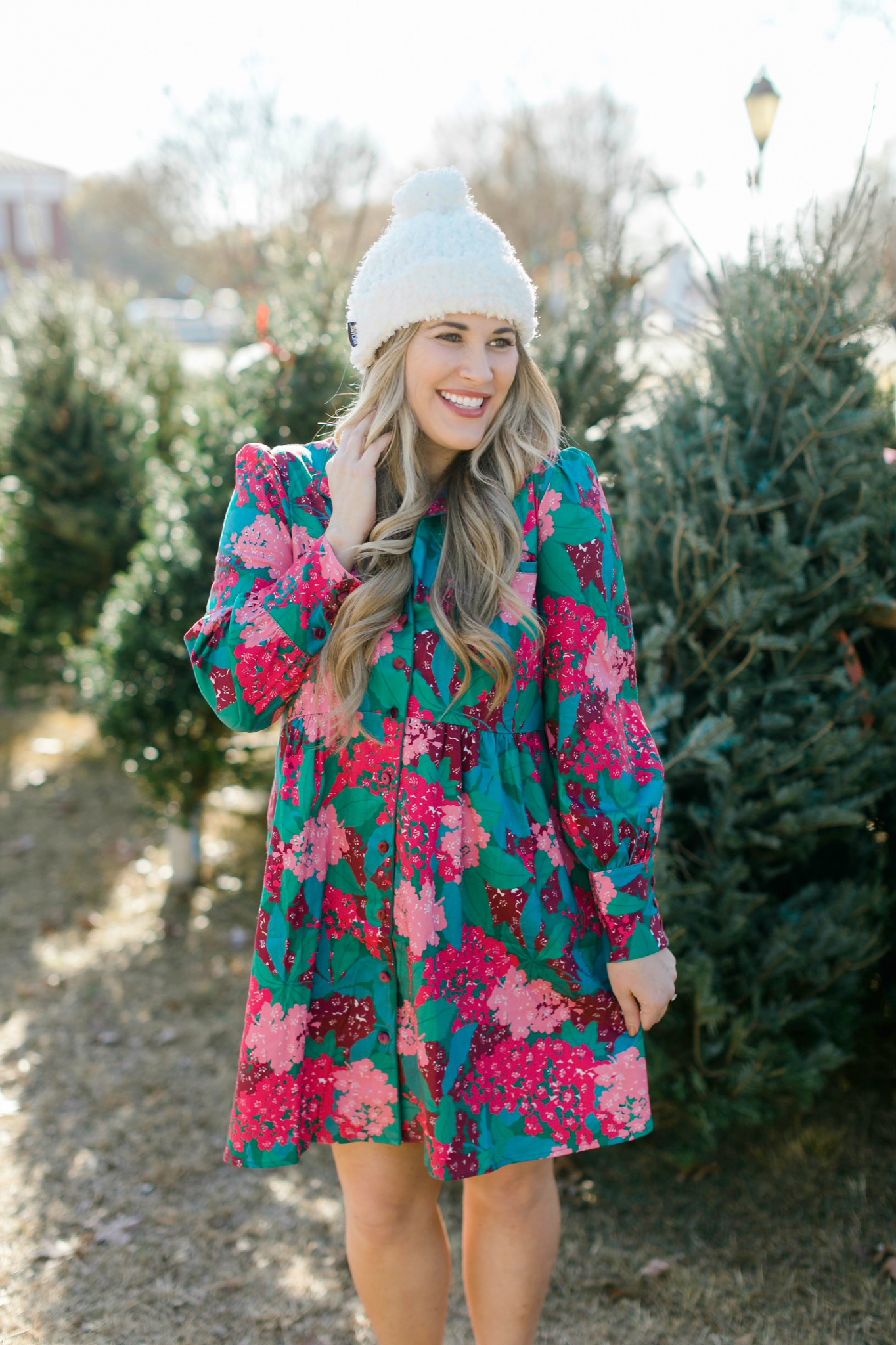 Winter floral look styled by top Memphis fashion blogger, Walking in Memphis in High Heels: image of a woman wearing a Tuckernuck floral shirt dress, Vince Camuto Selindra pumps and MUK LUKS pom hat.