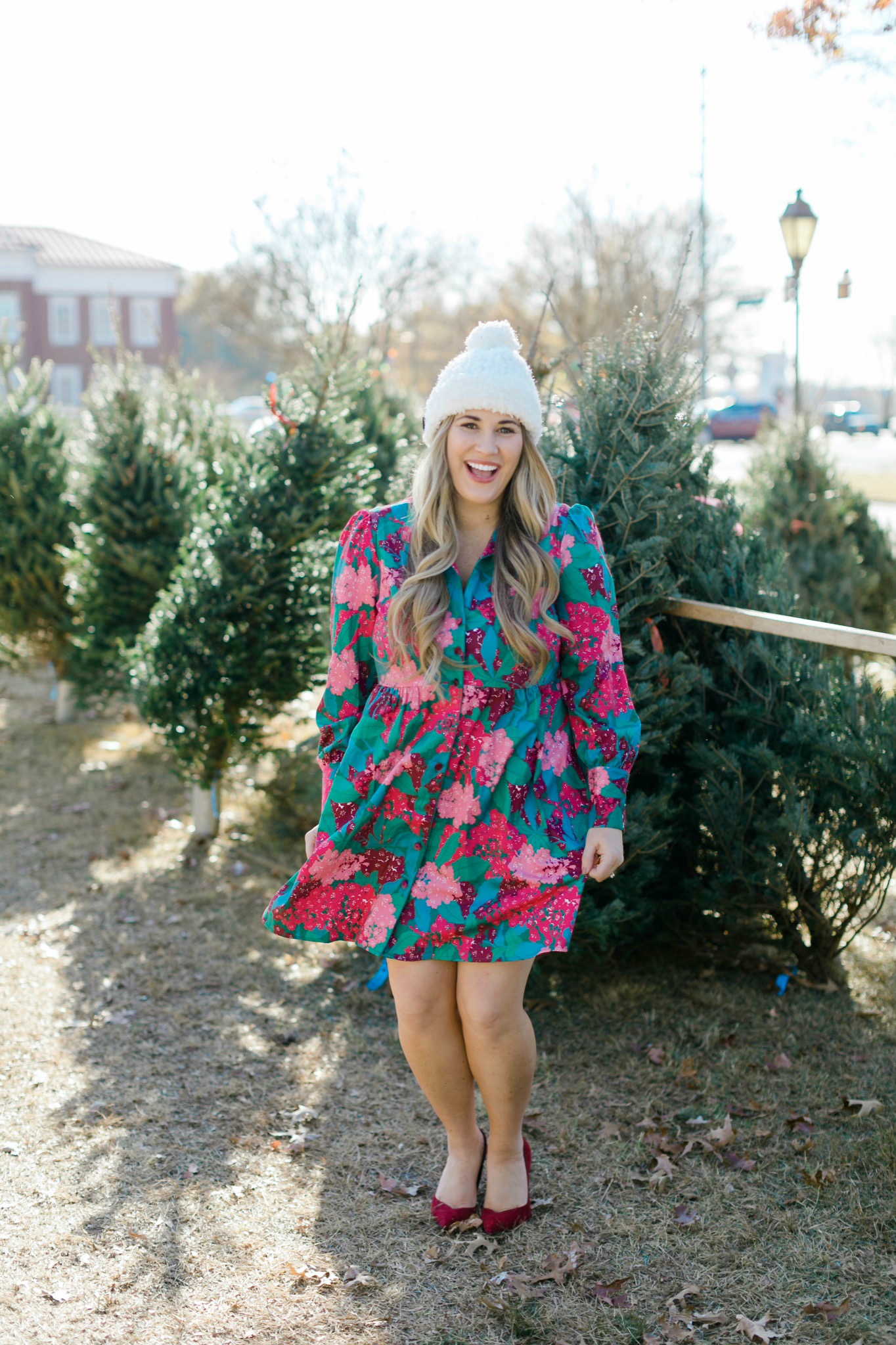 Winter floral look styled by top Memphis fashion blogger, Walking in Memphis in High Heels: image of a woman wearing a Tuckernuck floral shirt dress, Vince Camuto Selindra pumps and MUK LUKS pom hat.