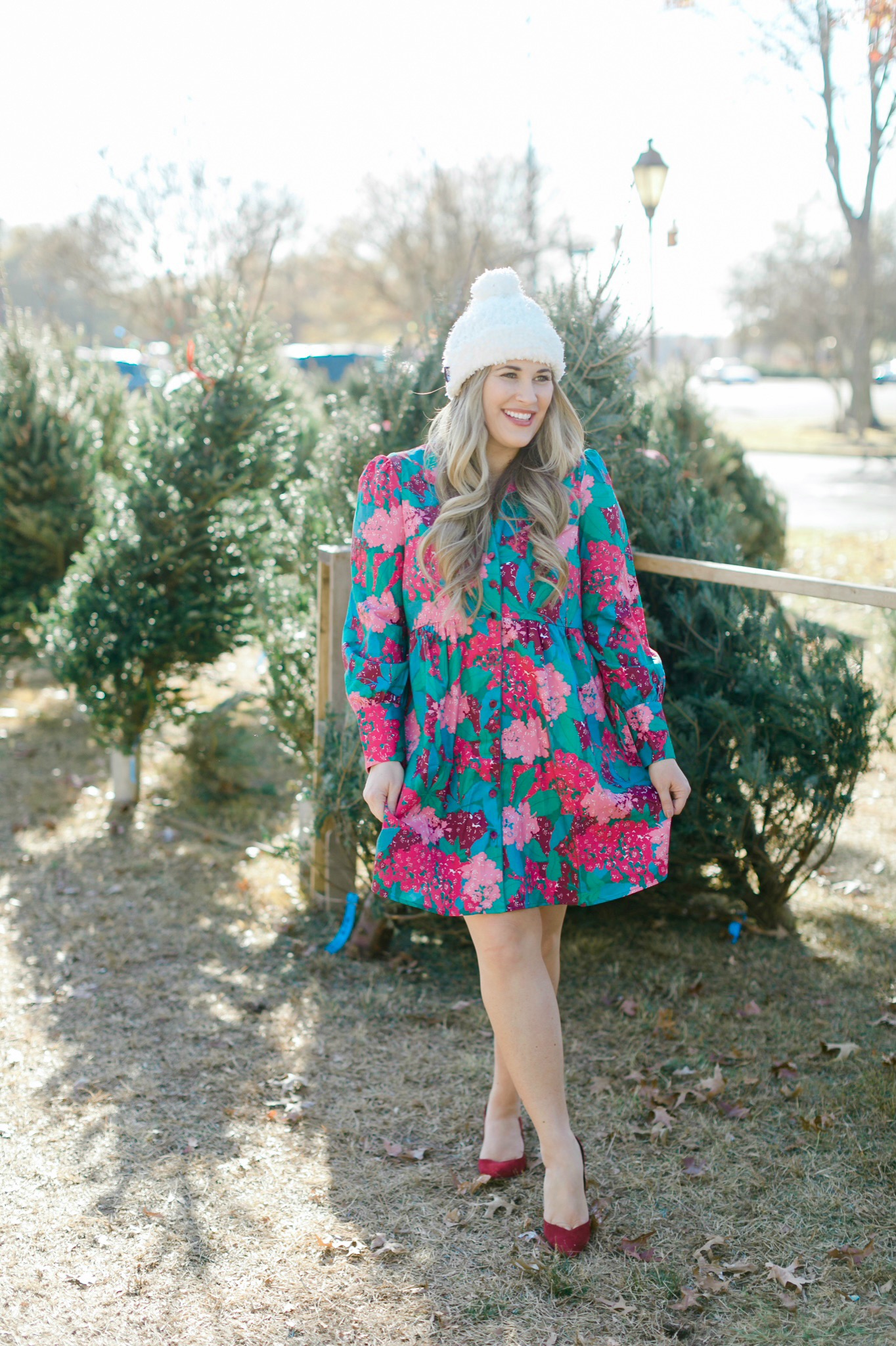 Winter floral look styled by top Memphis fashion blogger, Walking in Memphis in High Heels: image of a woman wearing a Tuckernuck floral shirt dress, Vince Camuto Selindra pumps and MUK LUKS pom hat.