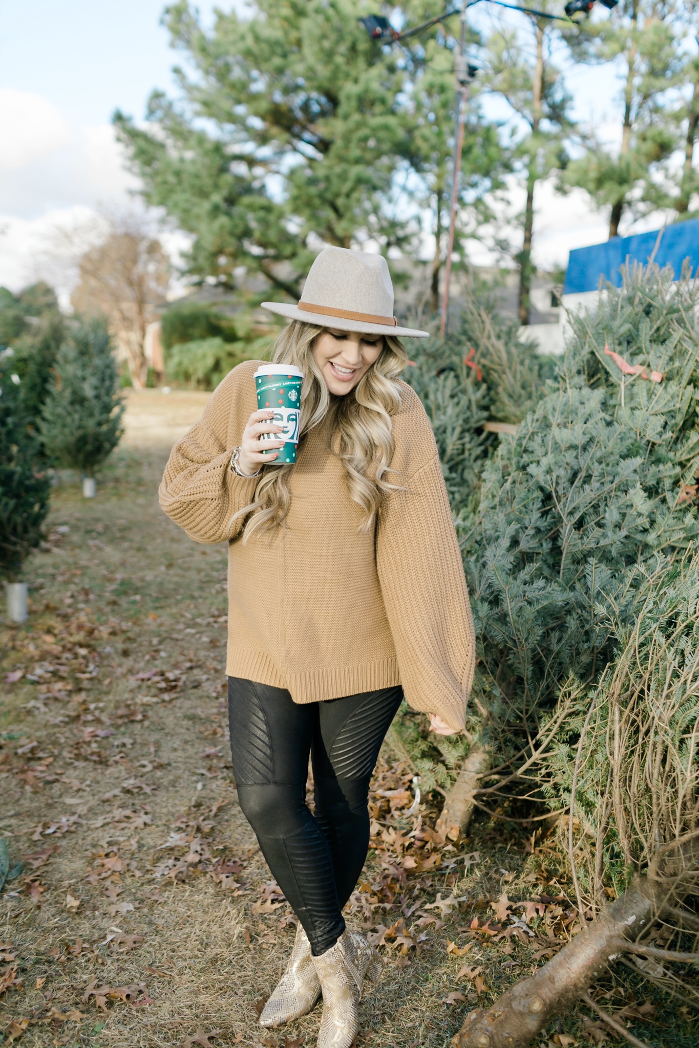 How to Wear a Sweater with Leggings, tips featured by top Memphis fashion blogger, Walking in Memphis in High Heels: image of a woman wearing Red Dress Camel Sweater and SPANX faux leather motto leggings