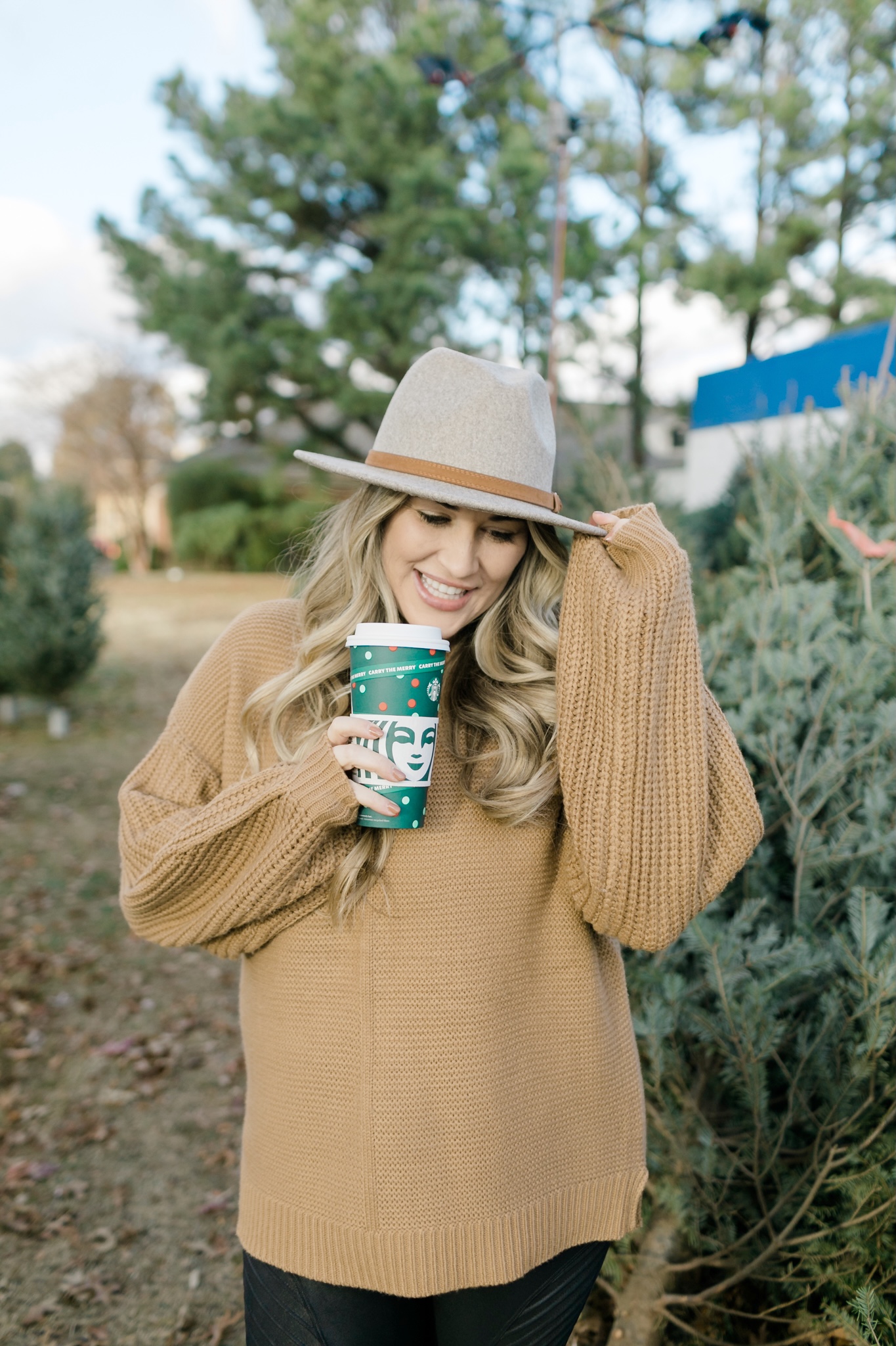 How to Wear a Sweater with Leggings, tips featured by top Memphis fashion blogger, Walking in Memphis in High Heels: image of a woman wearing Red Dress Camel Sweater and SPANX faux leather motto leggings