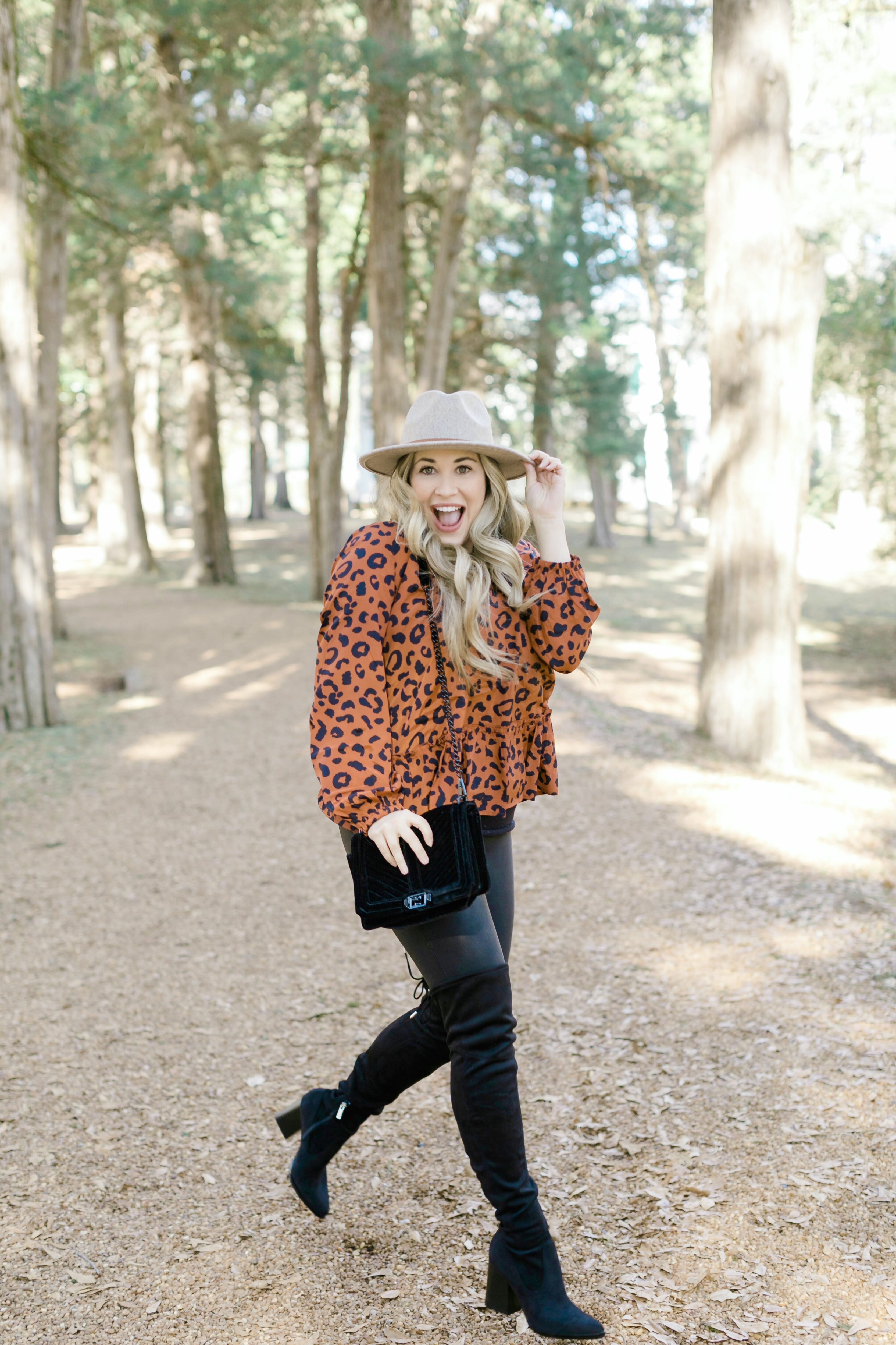 In a pair of bright red leggings, a black crochet top and fuzzy-lined high  heel