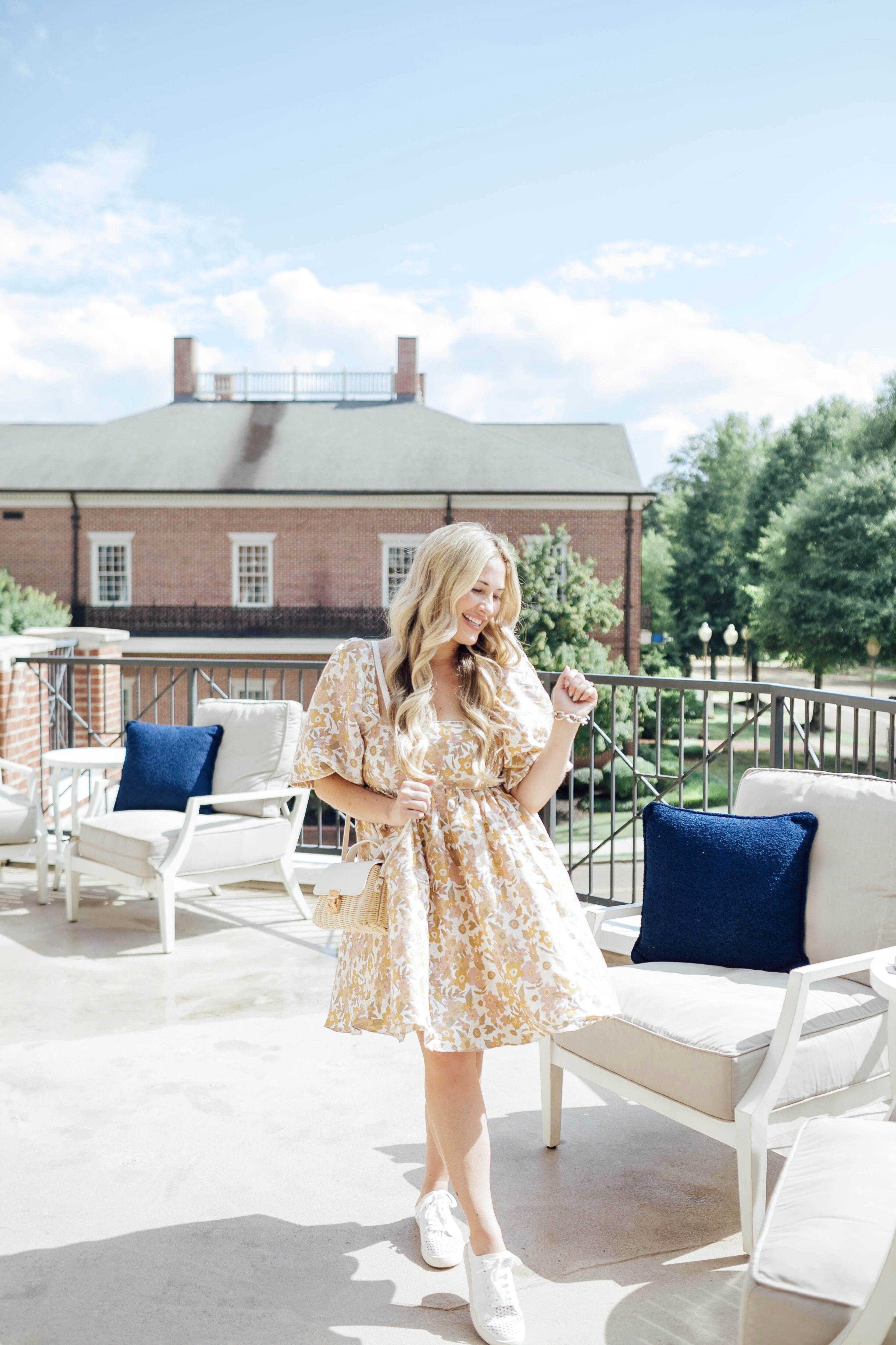 Cute White Sneakers for women styled by top US mom fashion blogger, Walking in Memphis in High Heels: image of a woman wearing Red Dress Mule White Sneakers